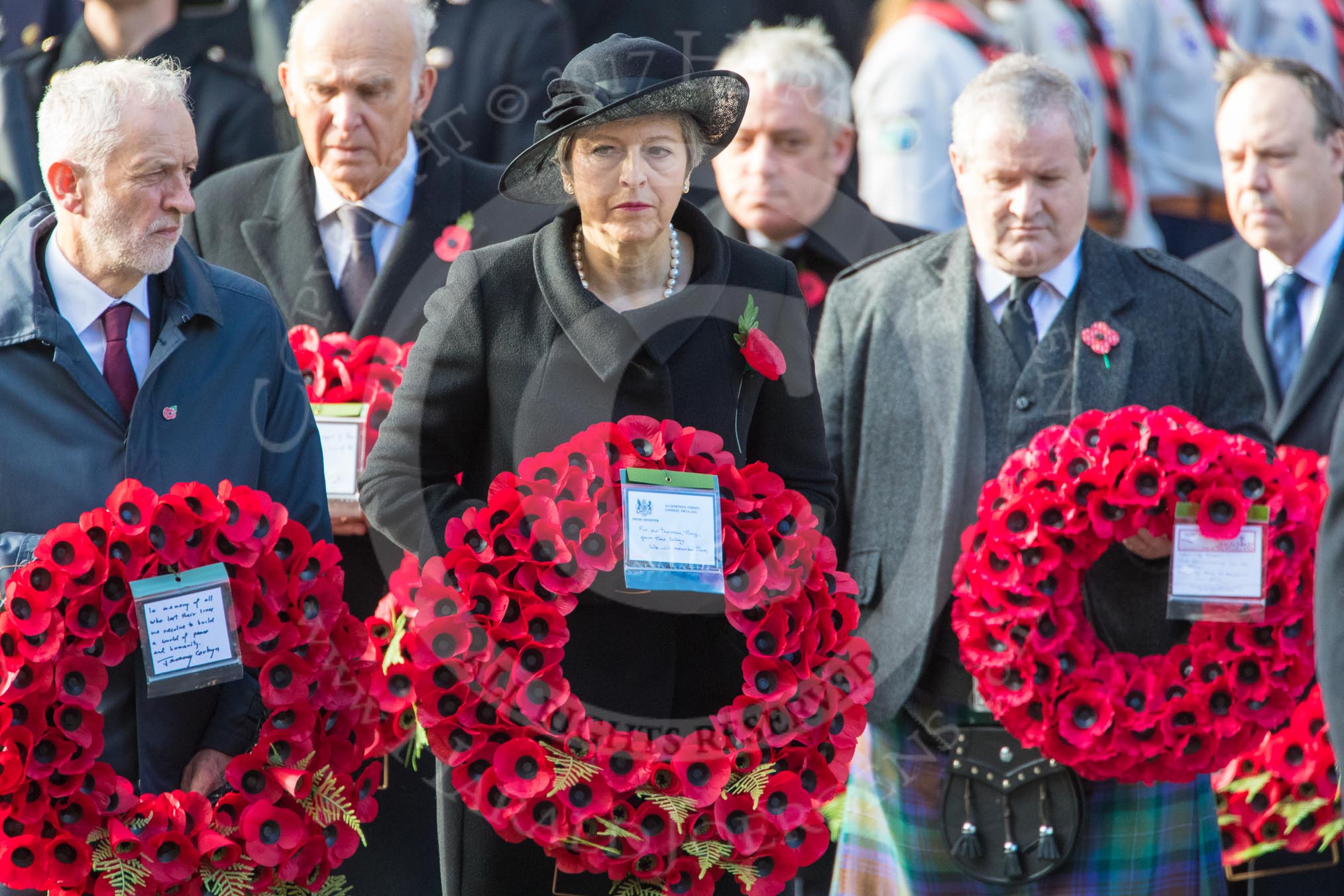 The Rt Hon Jeremy Corbyn MP, (Leader of the Labour Party and Leader of the Opposition), The Rt Hon Theresa May MP, Prime Minister, on behalf of the Government, and Mr Ian Blackford MP (the Westminster Scottish National Party Leader on the behalf of the SNP/the Plaid Cymru Parliamentary Group)  with their wreaths during Remembrance Sunday Cenotaph Ceremony 2018 at Horse Guards Parade, Westminster, London, 11 November 2018, 10:55.