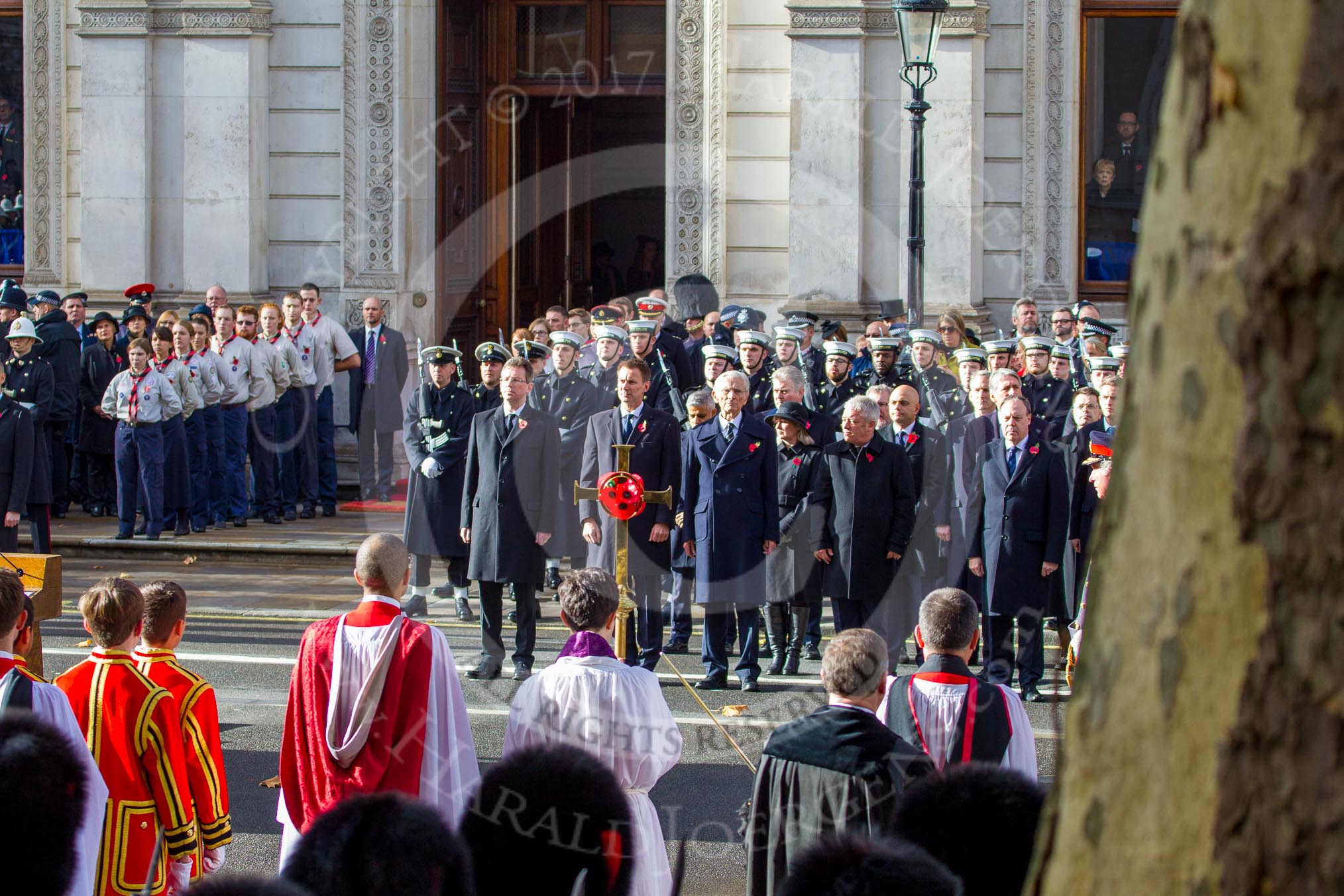 Whitehall, with the choir and cross bearer opposite the government during the Remembrance Sunday Cenotaph Ceremony 2018 at Horse Guards Parade, Westminster, London, 11 November 2018, 11:12.