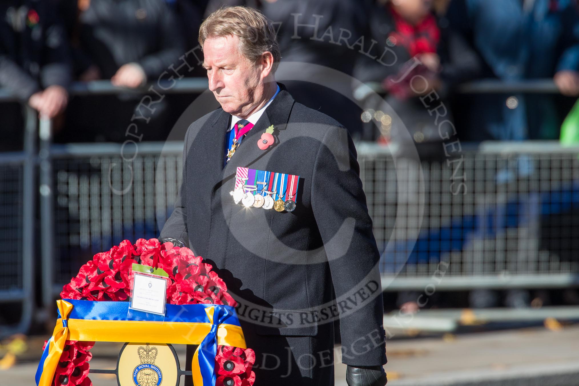 Air Marshal David Walker CB CBE AFC MA RAF (Retired), National President of the Royal British Legion, with the legion's wreath on the way to the Cenotaph during the  Remembrance Sunday Cenotaph Ceremony 2018 at Horse Guards Parade, Westminster, London, 11 November 2018, 11:28.