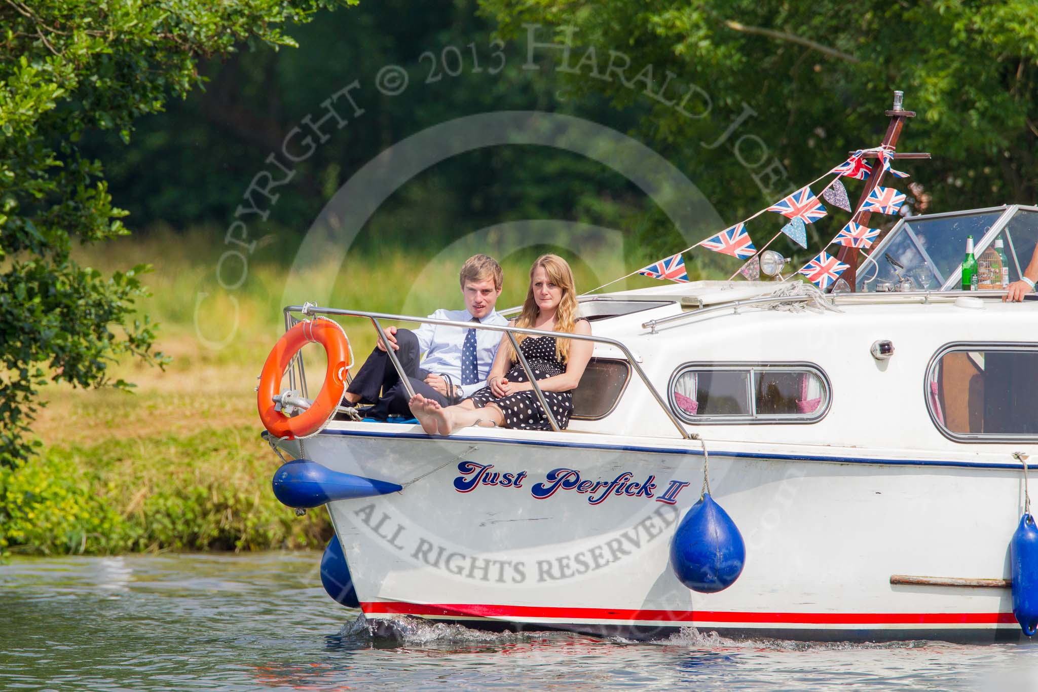 Henley Royal Regatta 2013, Saturday: Pleasure boat traffic next the the HRR race course - "Just Perfick II" with a young couple. Image #162, 06 July 2013 10:54 River Thames, Henley on Thames, UK