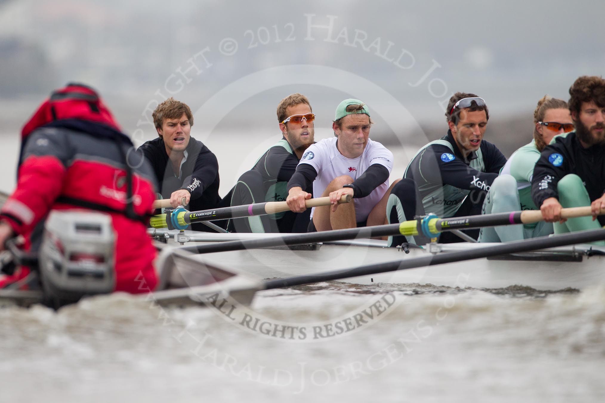 Cambridge University Boat Club Blue Boat during an outing on the River Thames, two days before the 2012 Boat Race. Bow man David Nelson, Moritz Schramm, Jack Lindeman, Alex Ross, and Steve Dudek. On the left CUBC chief coach Steve Trapmore.