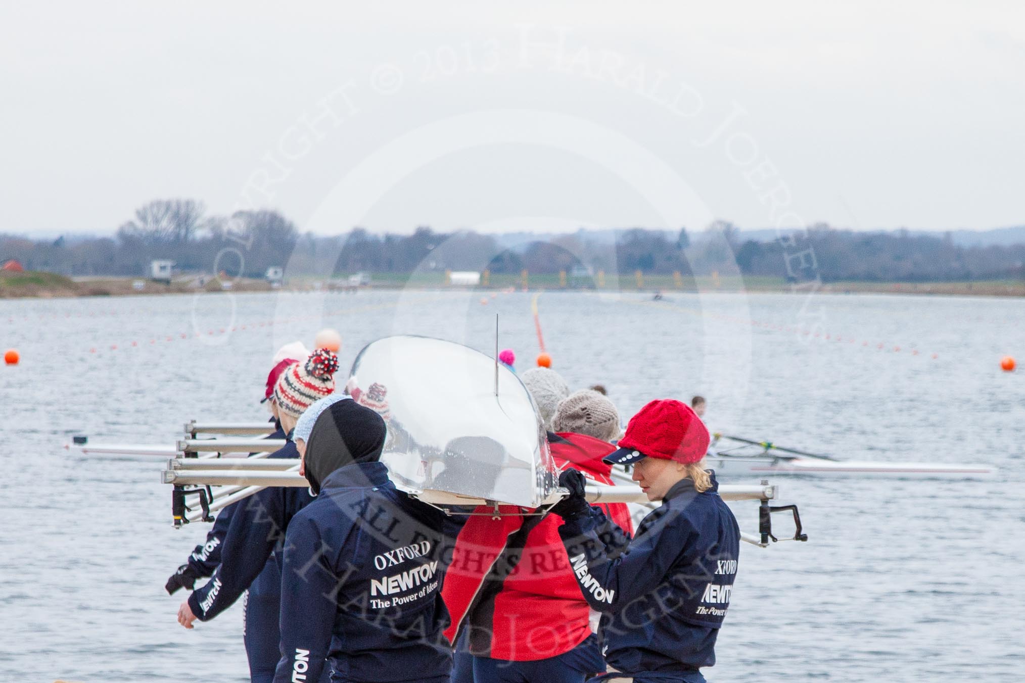 The Boat Race season 2013 - fixture OUWBC vs Molesey BC: The OUWBC Blue Boat crew carrying their boat towards Dorney Lake for a training session: Getting ready in the OUWBC boat: 7 seat Anastasia Chitty on the left, stroke Maxie Scheske on the right..
Dorney Lake,
Dorney, Windsor,
Berkshire,
United Kingdom,
on 24 February 2013 at 11:12, image #18