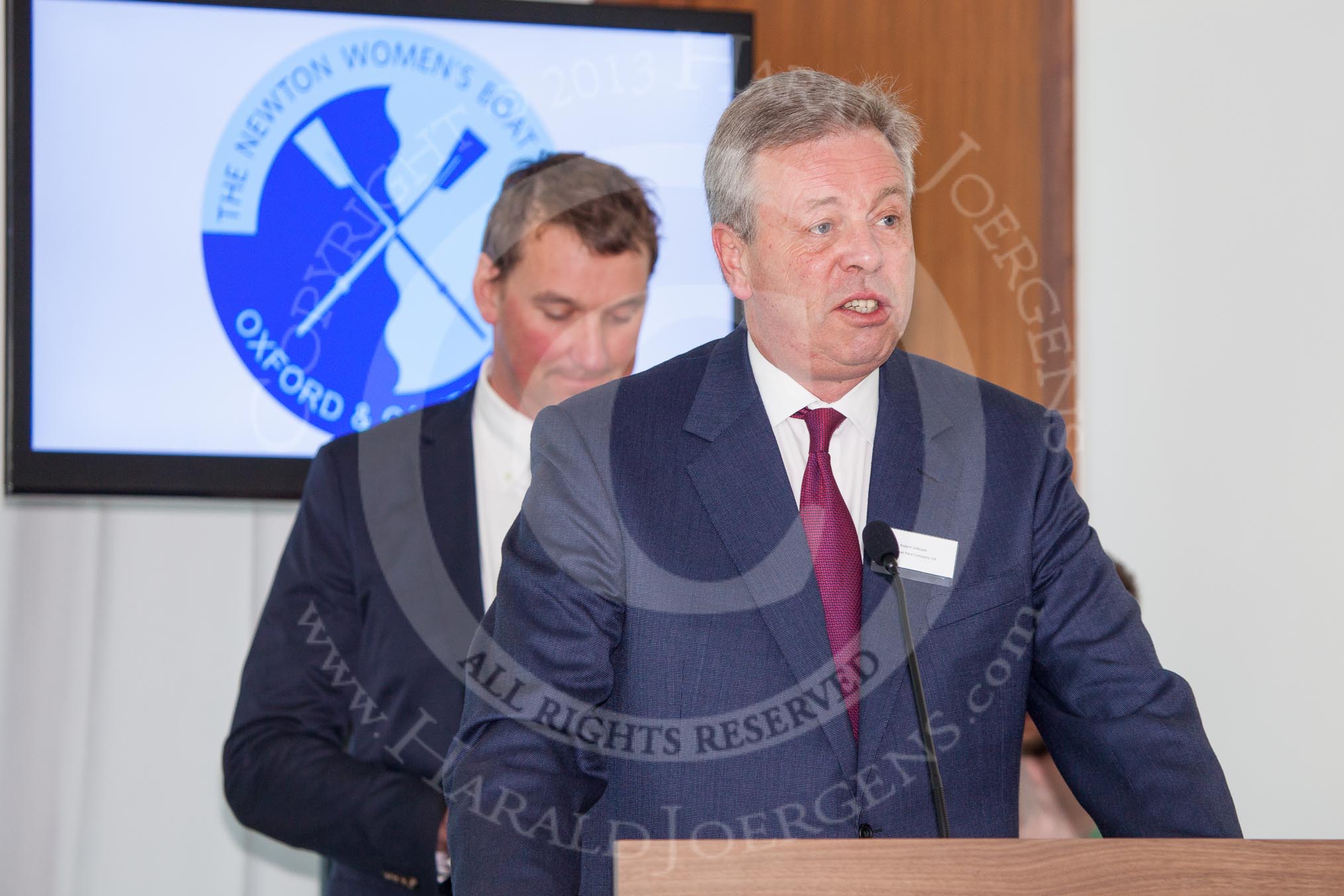 The Boat Race season 2013 - Crew Announcement and Weigh In: Robert Gillespie, chairman of The Boat Race Company Ltd. In the background Sir Matthew Pinsent..
BNY Mellon Centre,
London EC4V 4LA,

United Kingdom,
on 04 March 2013 at 10:13, image #6