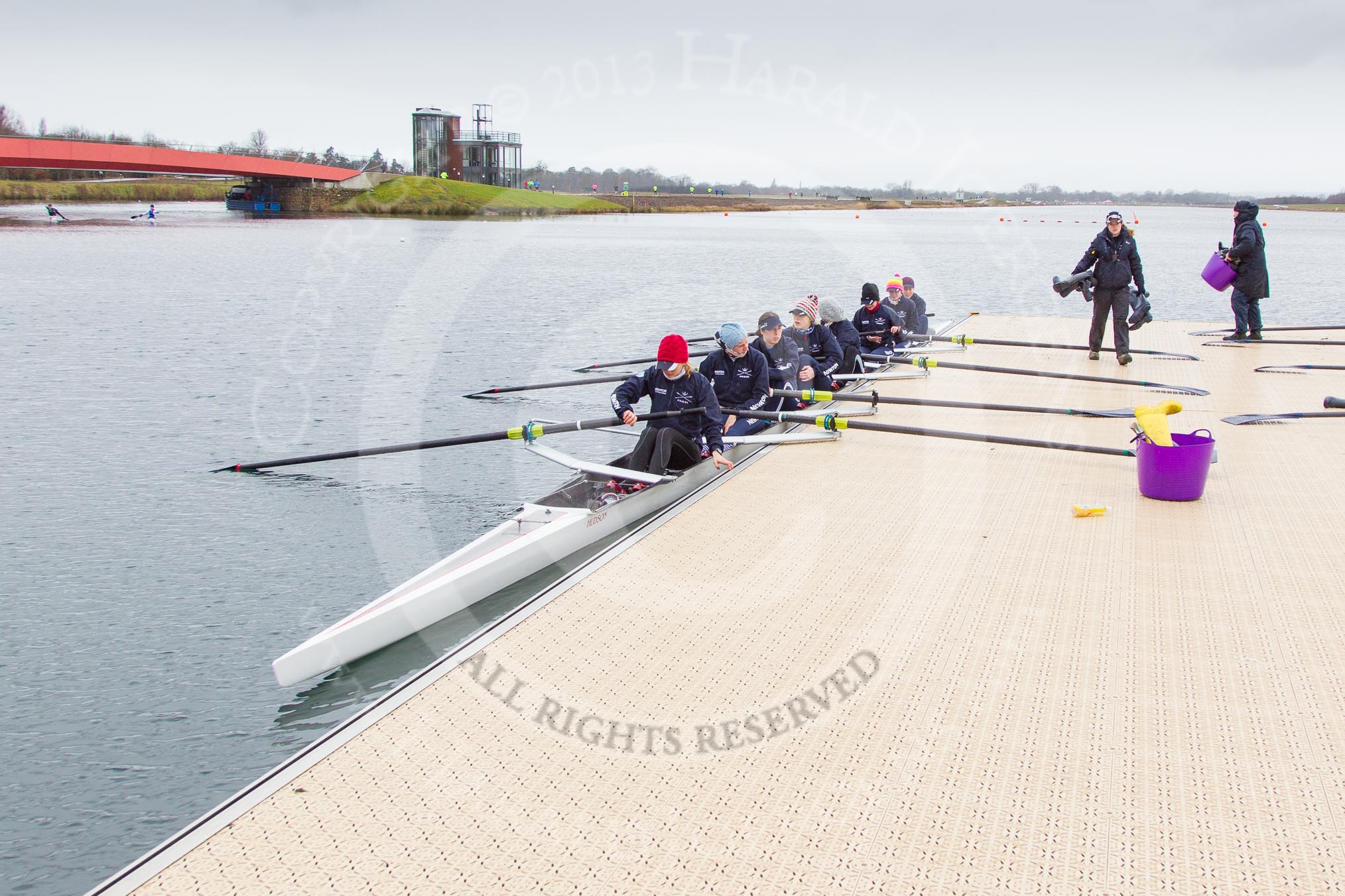 The Boat Race season 2013 - fixture OUWBC vs Olympians: The OUWBC Blue Boat getting ready at a Dorney Lake pontoon to meet the Olympians. On the left one of the bridges over the return/warm up-channel/.
Dorney Lake,
Dorney, Windsor,
Buckinghamshire,
United Kingdom,
on 16 March 2013 at 11:02, image #12