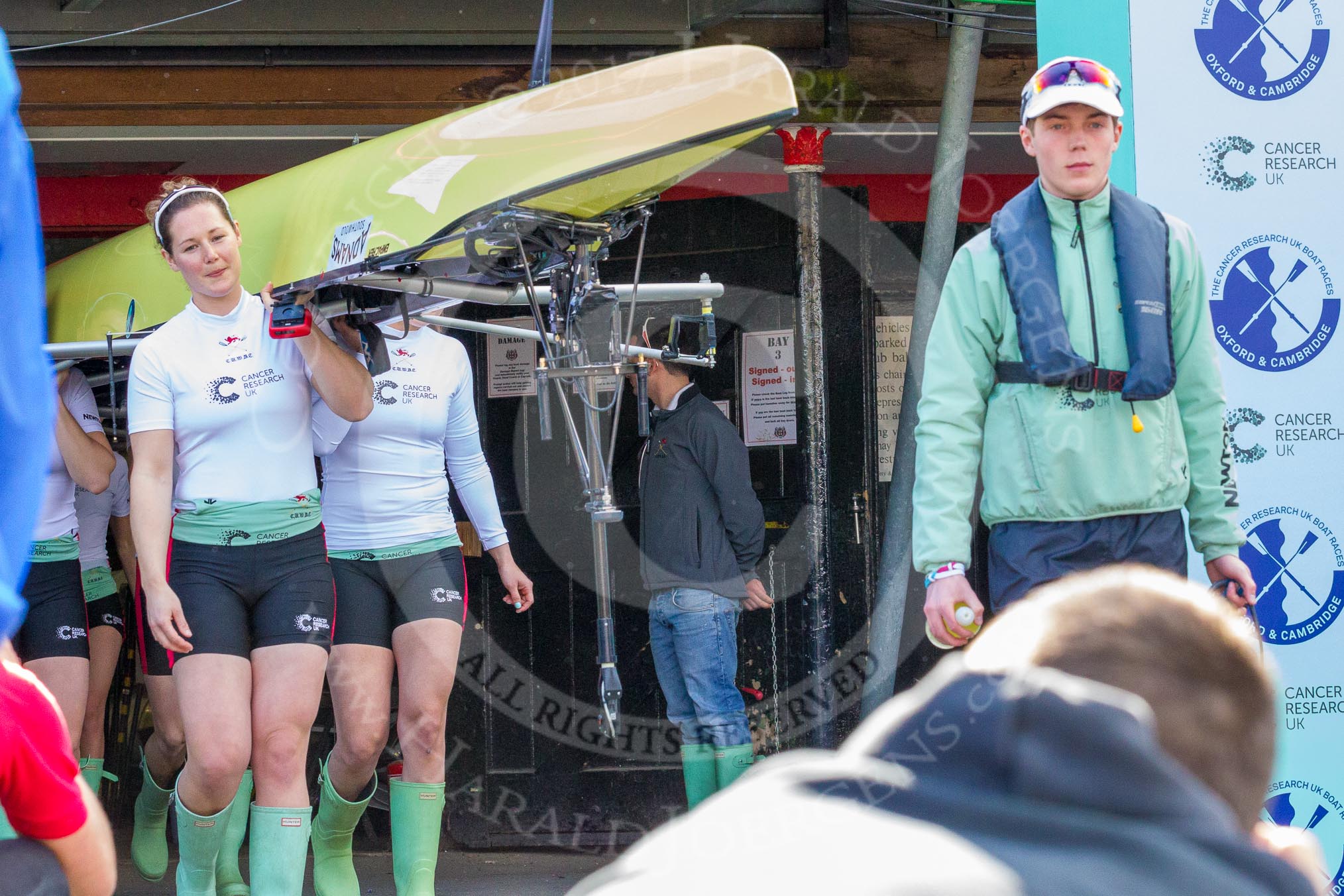 The Boat Race season 2017 -  The Cancer Research Women's Boat Race: The Cambridge crew carrying their boat from the boat house to the river, on the left CUWBC stroke Melissa Wilson.
River Thames between Putney Bridge and Mortlake,
London SW15,

United Kingdom,
on 02 April 2017 at 15:47, image #49