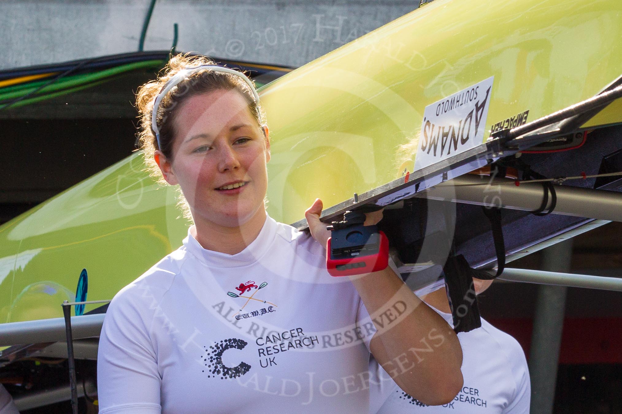 The Boat Race season 2017 -  The Cancer Research Women's Boat Race: CUWBC stroke Melissa Wilson carrying the Cambridge boat from the boat house to the river.
River Thames between Putney Bridge and Mortlake,
London SW15,

United Kingdom,
on 02 April 2017 at 15:47, image #51