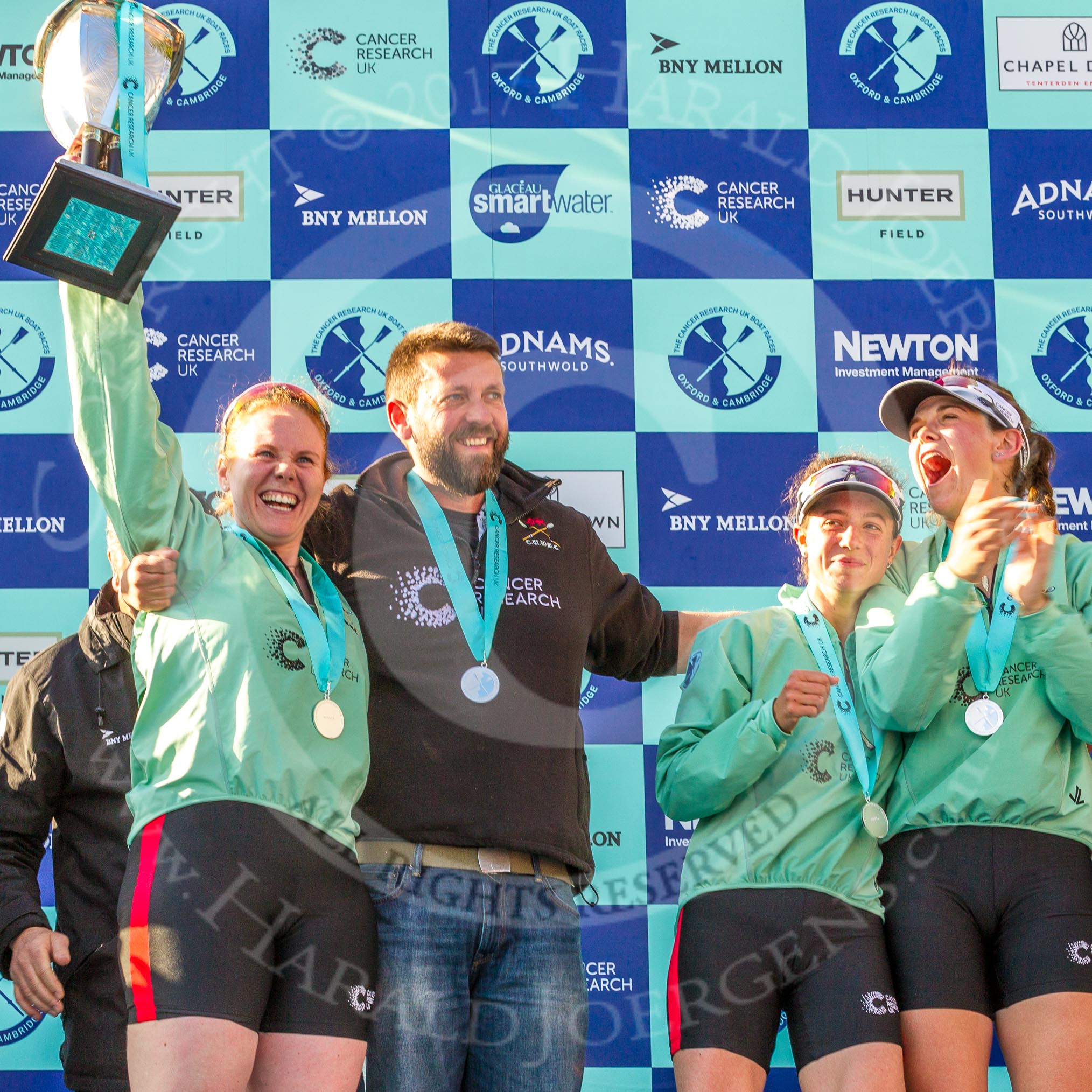 The Boat Race season 2017 -  The Cancer Research Women's Boat Race: CUWBC celebrating their win with the Women's Boat Race trophy - cox Ashton Brown, head coach Rob Barker,.
River Thames between Putney Bridge and Mortlake,
London SW15,

United Kingdom,
on 02 April 2017 at 17:11, image #238