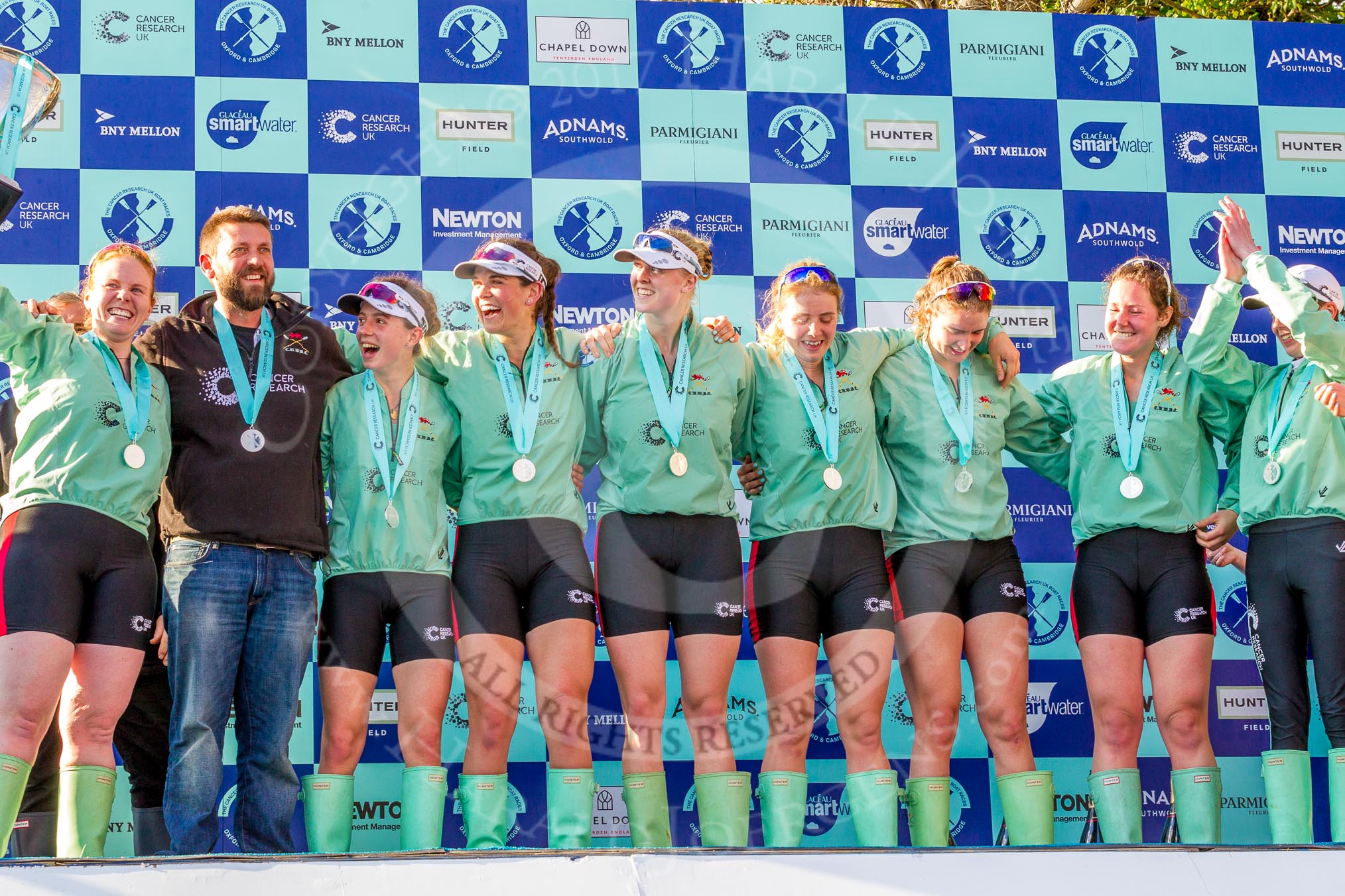 The Boat Race season 2017 -  The Cancer Research Women's Boat Race: CUWBC at the price giving - bow Ashton Brown with the Boat Race Tropy, head coach Rob Barker, 2 seat Imogen Grant, 3 seat Claire Lambe, 5 seat Holly Hill, 6 seat Alice White, 7 seat Myriam Goudet, stroke Melissa Wilson, and cox Matthew Holland.
River Thames between Putney Bridge and Mortlake,
London SW15,

United Kingdom,
on 02 April 2017 at 17:11, image #240