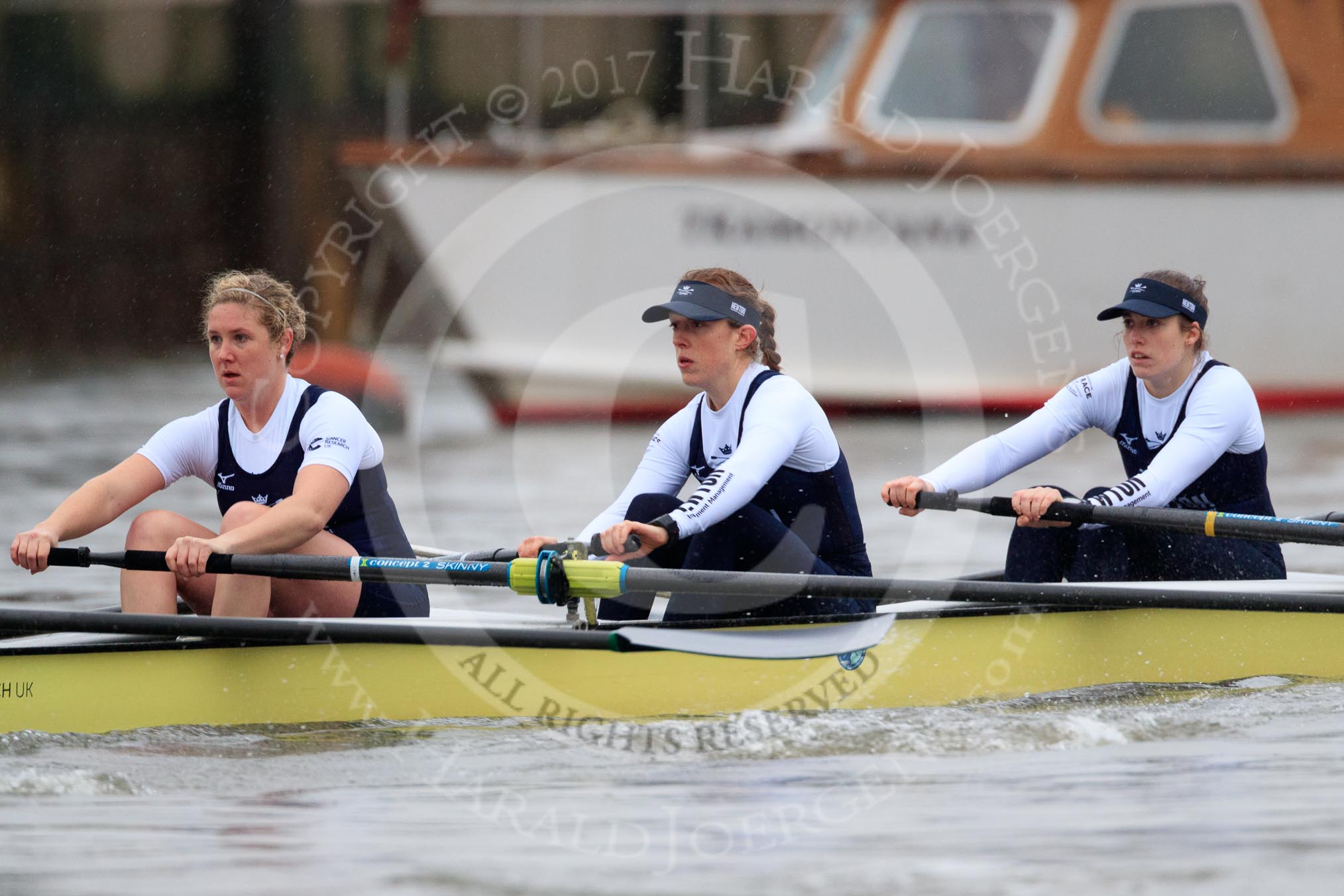 The Boat Race season 2018 - Women's Boat Race Trial Eights (OUWBC, Oxford): "Coursing River" seconds after the race has been started - 5 Morgan McGovern, 4 Anna Murgatroyd, 3 Stefanie Zekoll.
River Thames between Putney Bridge and Mortlake,
London SW15,

United Kingdom,
on 21 January 2018 at 14:27, image #54