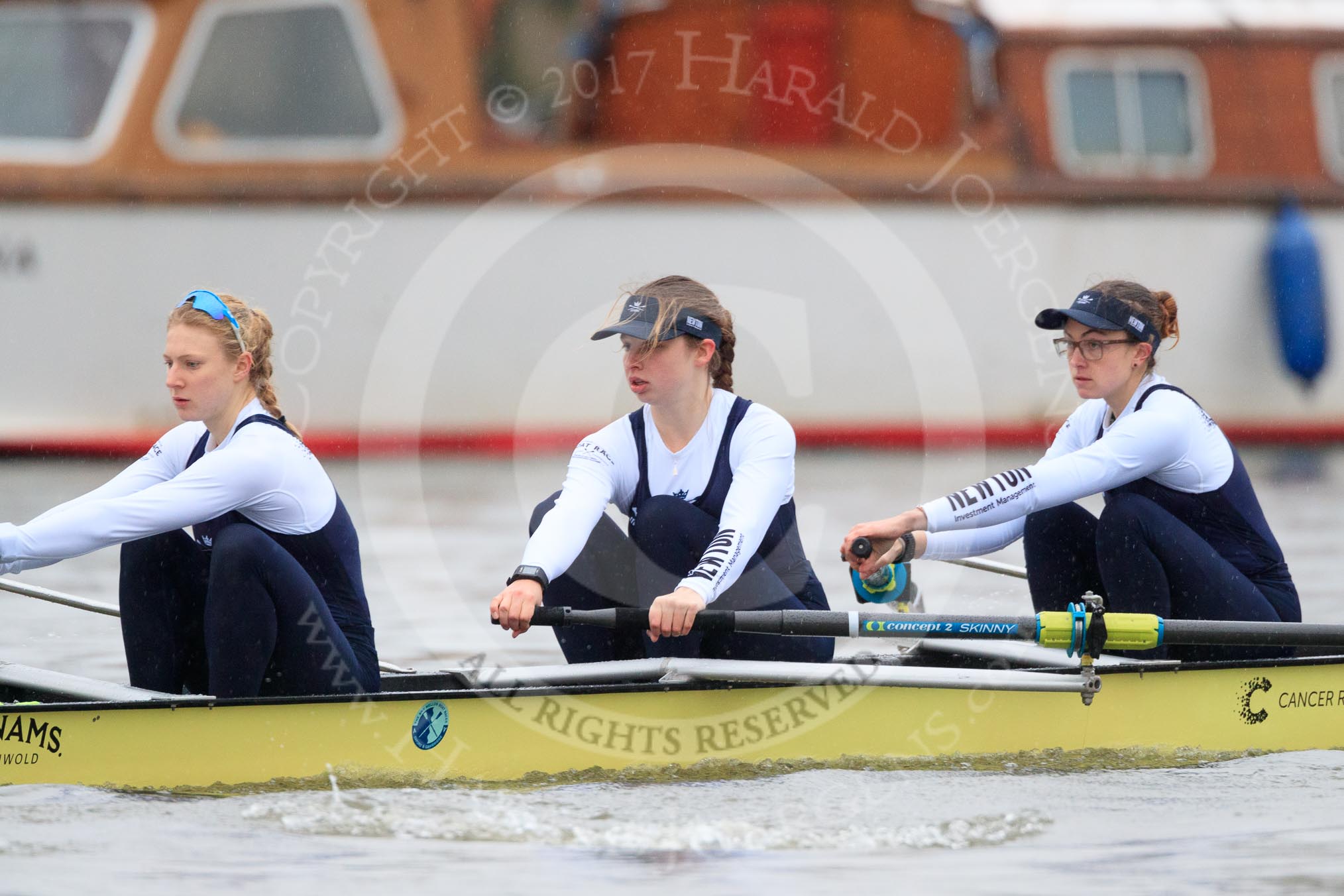 The Boat Race season 2018 - Women's Boat Race Trial Eights (OUWBC, Oxford): "Coursing River" seconds after the race has been started - stroke Beth Bridgman, 7 Juliette Perry, 6 Katherine Erickson.
River Thames between Putney Bridge and Mortlake,
London SW15,

United Kingdom,
on 21 January 2018 at 14:27, image #55