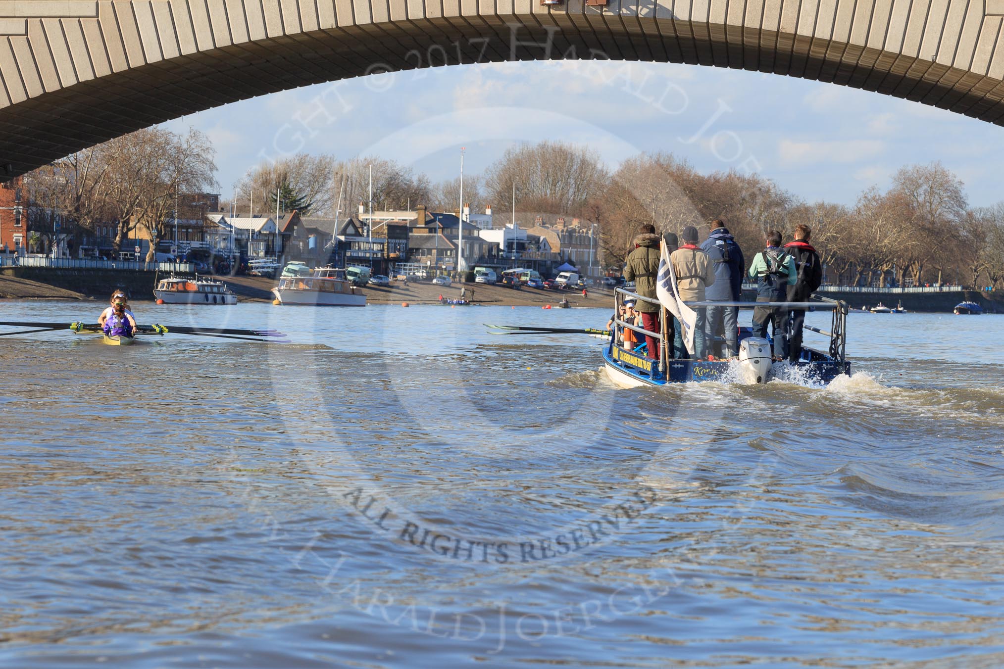 The Women's Boat Race season 2018 - fixture CUWBC vs. ULBC: ULBC, on the left, and CUWBC, in front of the umpire's boat, below Putney Bridge, rowuing towards their start positions.
River Thames between Putney Bridge and Mortlake,
London SW15,

United Kingdom,
on 17 February 2018 at 13:08, image #35