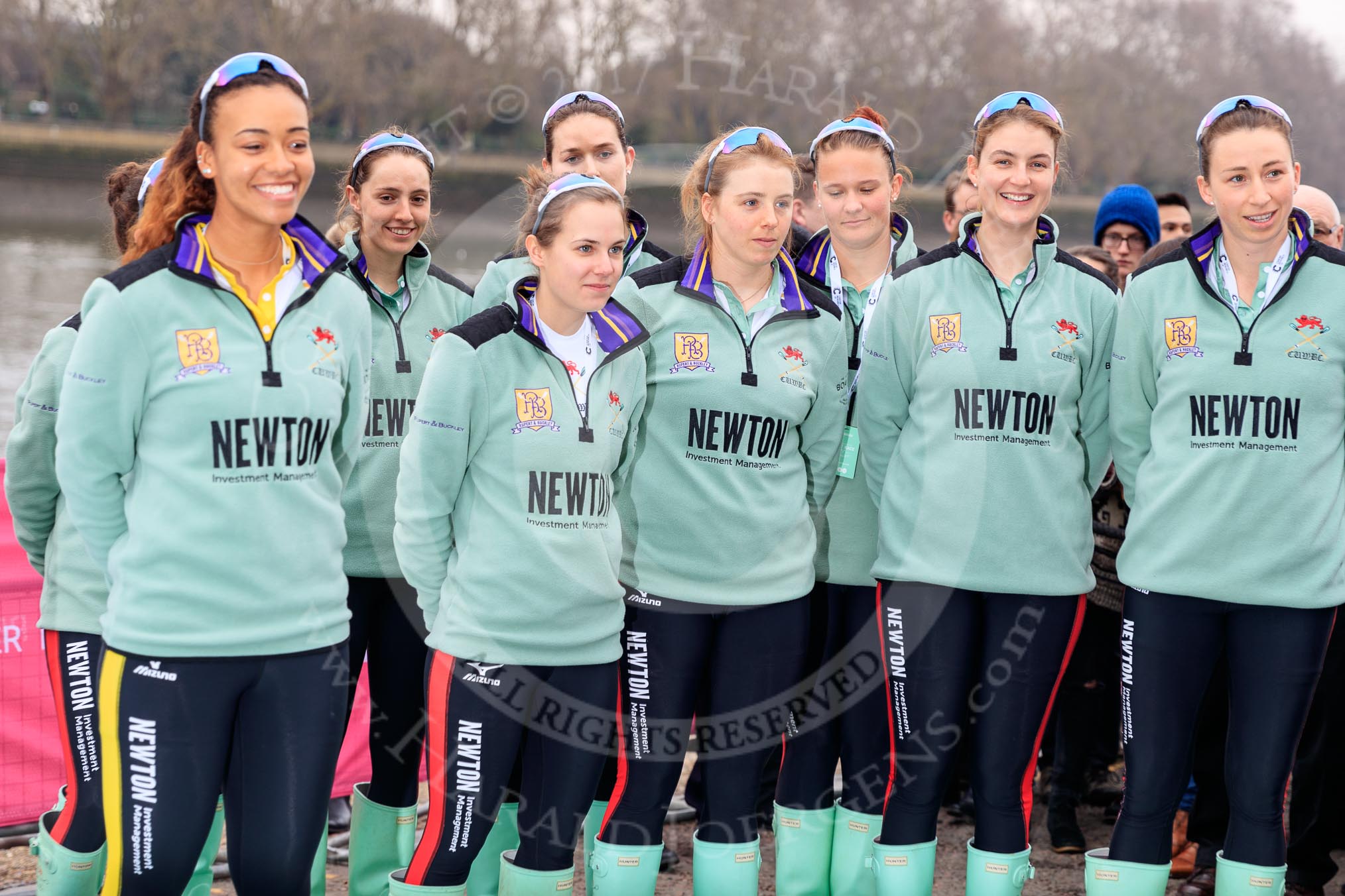 The Cancer Research UK Women's Boat Race 2018: The Cambridge crew  at the toss - president Daphne Martschenko (rowing in the reserve boat), cox Sophie Shapter, 6 Alice White, 7 Myriam Goudet-Boukhatmi, and in the second row 2 seat Imogen Grant, 3 Kelsey Barolak, 4 Thea Zabell, and 5 Paula Wesselmann. On the right race umpire Sir Matthew Pinsent..
River Thames between Putney Bridge and Mortlake,
London SW15,

United Kingdom,
on 24 March 2018 at 14:41, image #50