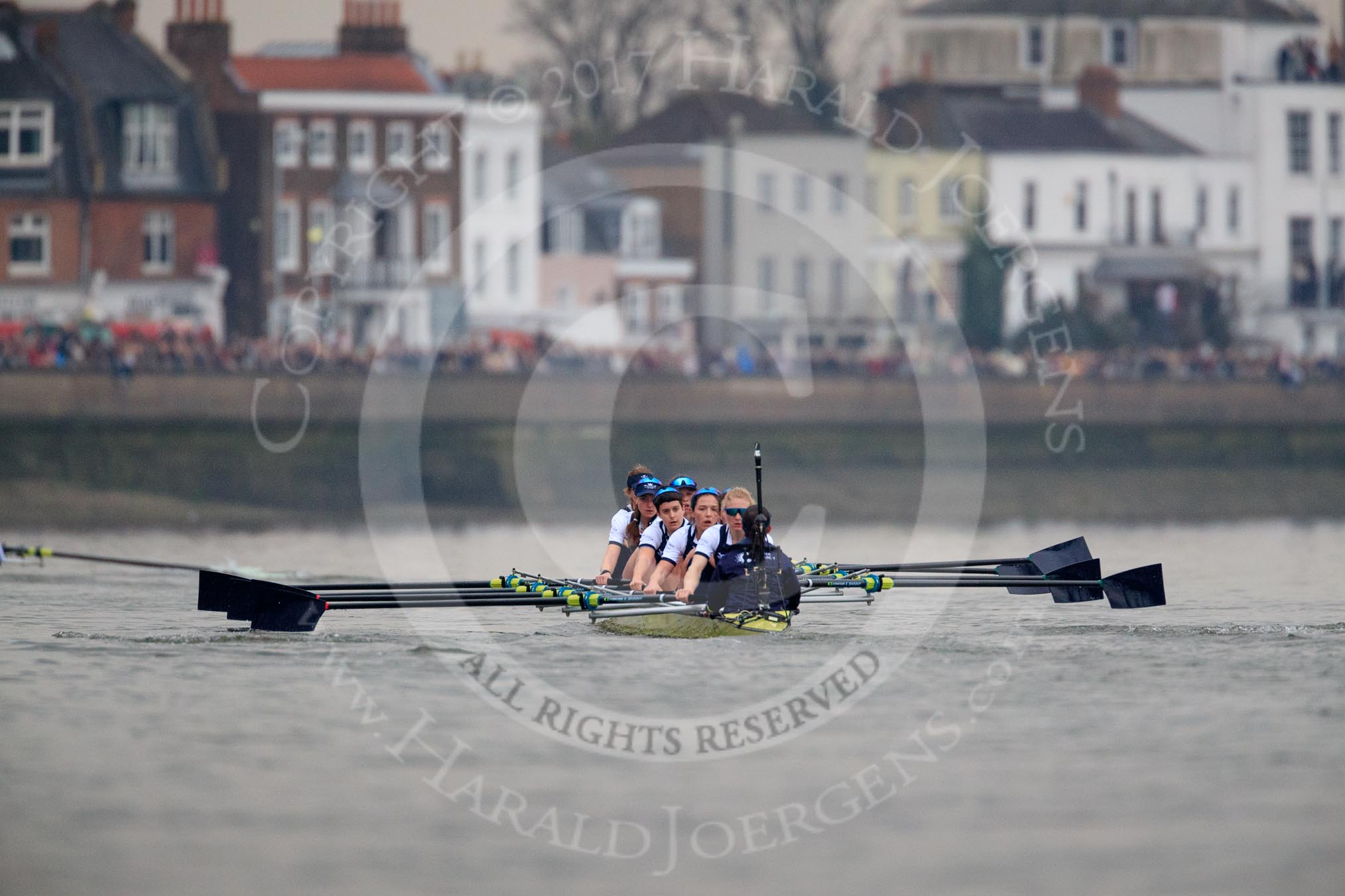 The Cancer Research UK Women's Boat Race 2018: The Cambridge boat is just visible on the left as they extend their lead. In the Bandstand area, here the Oxfford boat with bow Renée Koolschijn, 2 Katherine Erickson, 3 Juliette Perry, 4 Alice Roberts, 5 Morgan McGovern, 6 Sara Kushma, 7 Abigail Killen, stroke Beth Bridgman, cox Jessica Buck.
River Thames between Putney Bridge and Mortlake,
London SW15,

United Kingdom,
on 24 March 2018 at 16:45, image #189