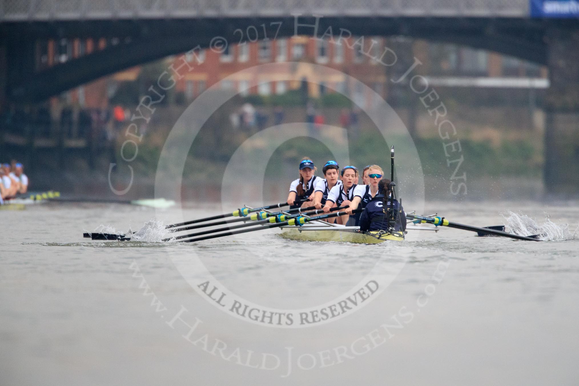 The Cancer Research UK Women's Boat Race 2018: Near Barnes Bridge, the Cambridge boat, just visible on the left, is getting further ahead. In the Oxford boat bow Renée Koolschijn, 2 Katherine Erickson, 3 Juliette Perry, 4 Alice Roberts, 5 Morgan McGovern, 6 Sara Kushma, 7 Abigail Killen, stroke Beth Bridgman, cox Jessica Buck.
River Thames between Putney Bridge and Mortlake,
London SW15,

United Kingdom,
on 24 March 2018 at 16:46, image #192