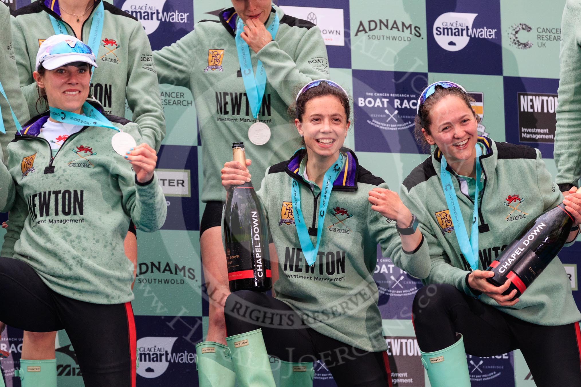 The Cancer Research UK Women's Boat Race 2018: The Cambridge women celebrating with their Boat Race medals and lots of Chapel Down Brut: Sophie Shapter, Imogen Grant, and Tricia Smith.
River Thames between Putney Bridge and Mortlake,
London SW15,

United Kingdom,
on 24 March 2018 at 17:09, image #296