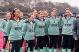 The Cancer Research UK Women's Boat Race 2018: The Cambridge crew  at the toss - president Daphne Martschenko (rowing in the reserve boat), cox Sophie Shapter, 6 Alice White, 7 Myriam Goudet-Boukhatmi, and in the second row 3 Kelsey Barolak, 4 Thea Zabell, and 5 Paula Wesselmann. On the right race umpire Sir Matthew Pinsent..
River Thames between Putney Bridge and Mortlake,
London SW15,

United Kingdom,
on 24 March 2018 at 14:41, image #49