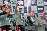 The Cancer Research UK Women's Boat Race 2018: The Cambridge women celebrating with their Boat Race medals, the Women's Boat Race trophy, and lots of Chapel Down Brut: Myriam Goudet-Boukhatmi, Sophie Shapter, Alice White, Paula Wesselmann.
River Thames between Putney Bridge and Mortlake,
London SW15,

United Kingdom,
on 24 March 2018 at 17:09, image #279