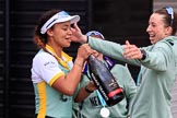 The Cancer Research UK Women's Boat Race 2018: Cambridge president Daphne Martschenko after the official ceremony, celebrating with a bottle of Chapel Down Brut. Behind her Alice White, on the right Olivia Coffey.
River Thames between Putney Bridge and Mortlake,
London SW15,

United Kingdom,
on 24 March 2018 at 17:16, image #324