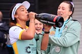 The Cancer Research UK Women's Boat Race 2018: Cambridge president Daphne Martschenko after the official ceremony, celebrating with a bottle of Chapel Down Brut. Behind her Alice White, on the right Olivia Coffey.
River Thames between Putney Bridge and Mortlake,
London SW15,

United Kingdom,
on 24 March 2018 at 17:16, image #323