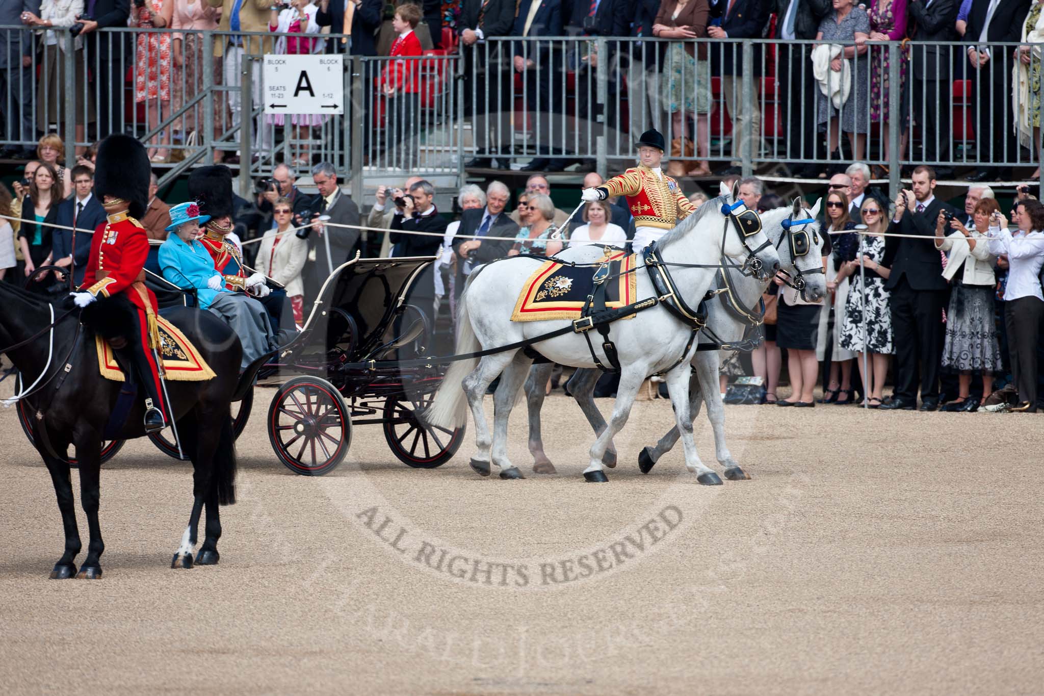 Trooping the Colour 2009: The Royal Procession passing the Colour Party, head coachman Jack Hargreaves salutes with his whip. In the ivory mounted phaeton HM The Queen and HRH The Duke of Edinburgh, on the very left the Adjutant of the Parade, Captain James Bullock-Webster..
Horse Guards Parade, Westminster,
London SW1,

United Kingdom,
on 13 June 2009 at 10:57, image #119