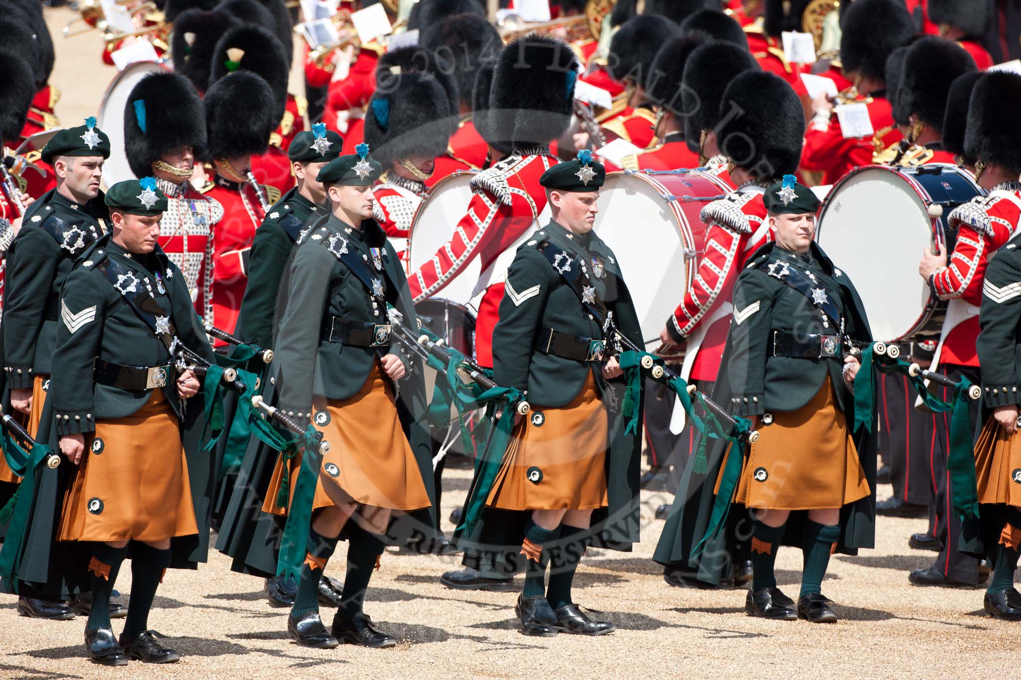 Trooping the Colour 2009: Irish Guards Pipers in their bottle green tunics and saffron coloured kilts with a bottle green cape, in front of Drummers..
Horse Guards Parade, Westminster,
London SW1,

United Kingdom,
on 13 June 2009 at 11:17, image #179