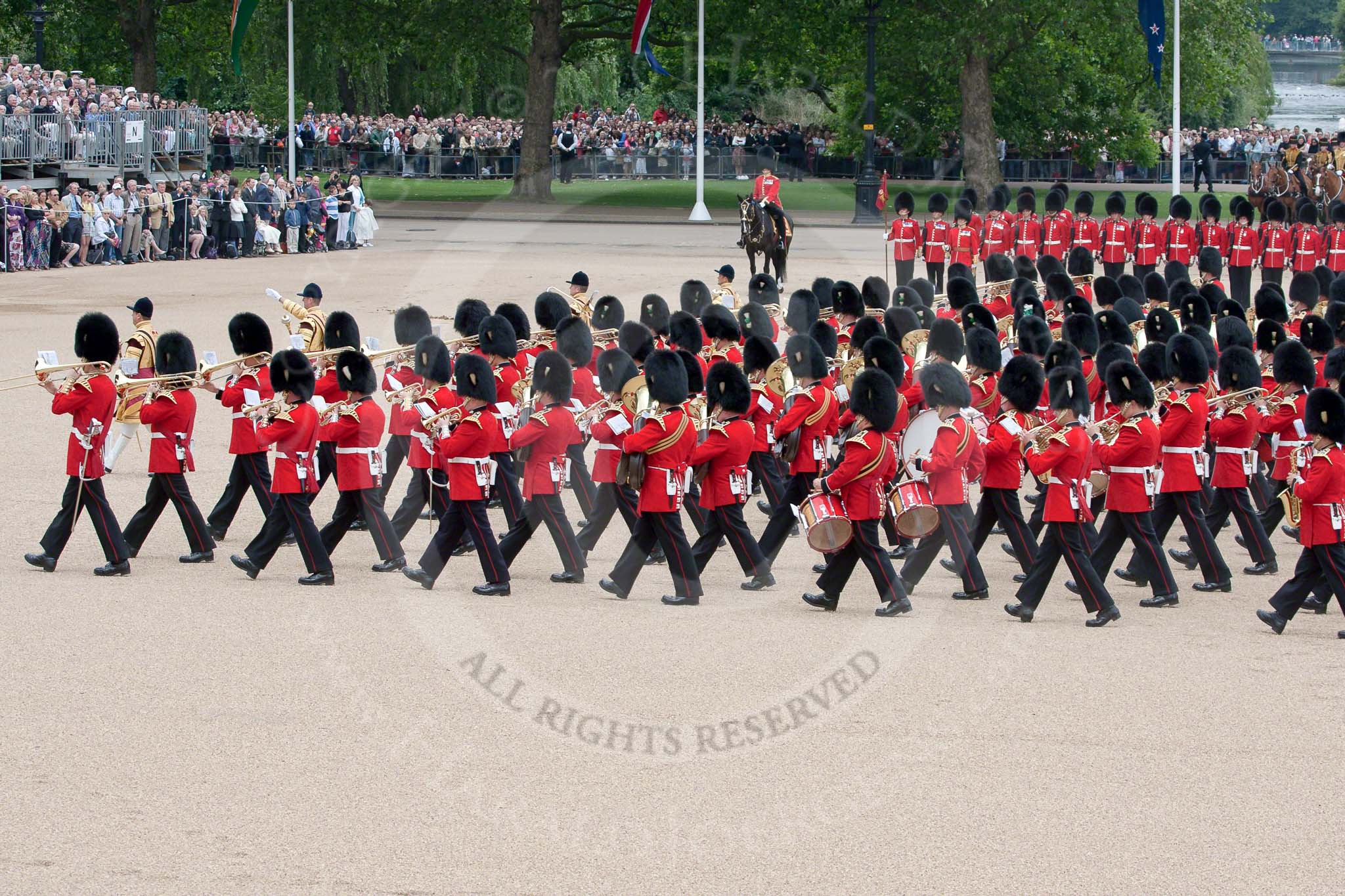 Trooping the Colour 2010: The Band of the Grenadier Guards (front) amd of the Welsh Guards (middle) are marching into their starting position for the parade.

On their right No. 1 Guard, 1st Battalion Grenadier Guards, the &quot;Escort for the Colour&quot;, behind them. on the very right, the &quot;King's Troop Royal Horse Artillery&quot;.

On the top of the photo spectators watching from St. James's Park, on the very left spectators in front of the No. 10 Downing Street Garden.

The Colour Sergeant (bottom middle) is observing the proceedings.

The bands of the Irish Guards (blue plumes on the bearskins) and Coldstream Guards (red plumes) have already taken their positions.

The public stands behind the bands are at the rear of the garden of No. 10 Downing Street..
Horse Guards Parade, Westminster,
London SW1,
Greater London,
United Kingdom,
on 12 June 2010 at 11:13, image #113