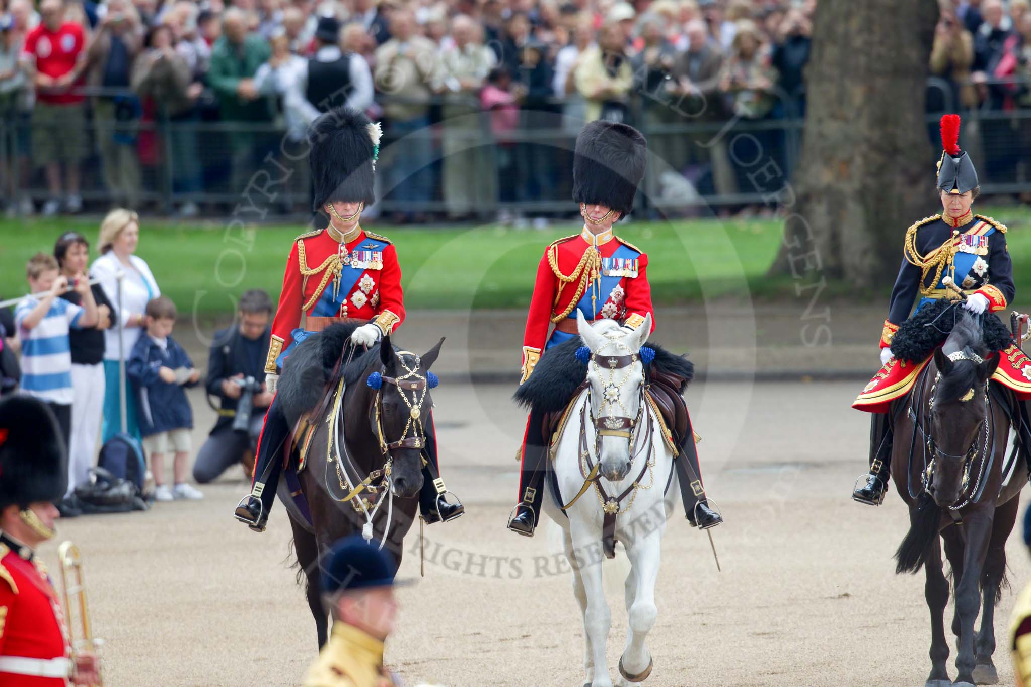 Trooping the Colour 2010: Three Royal Colonels following Her Majesty during the &quot;inspection of the line&quot;.

To the left, Charles, The Prince of Wales, Colonel of the Welsh Guards, in the middle Prince Edward, Duke of Kent, Colonel of the Scots Guards, and, on the right, Anne, The Princess Royal, Colonel of the Blues and Royals.

In the background spectators watching from St. James's Park at the western side of the parade ground, and in the foreground on of the Drum Majors..
Horse Guards Parade, Westminster,
London SW1,
Greater London,
United Kingdom,
on 12 June 2010 at 11:06, image #92