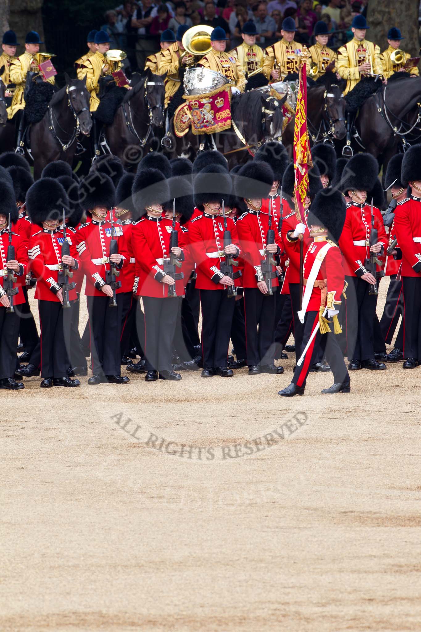 The Colonel's Review 2011: The Esnsign, Tom Ogilvy, is marching in front of the line of guards (here No. 4 Guard, Nijmegen Company Grenadier Guards, whilst the other guardsmen of the Escort are marching between the two lines of guards. In the background the Mounted Bands of the Household Cavalry..
Horse Guards Parade, Westminster,
London SW1,

United Kingdom,
on 04 June 2011 at 11:24, image #144