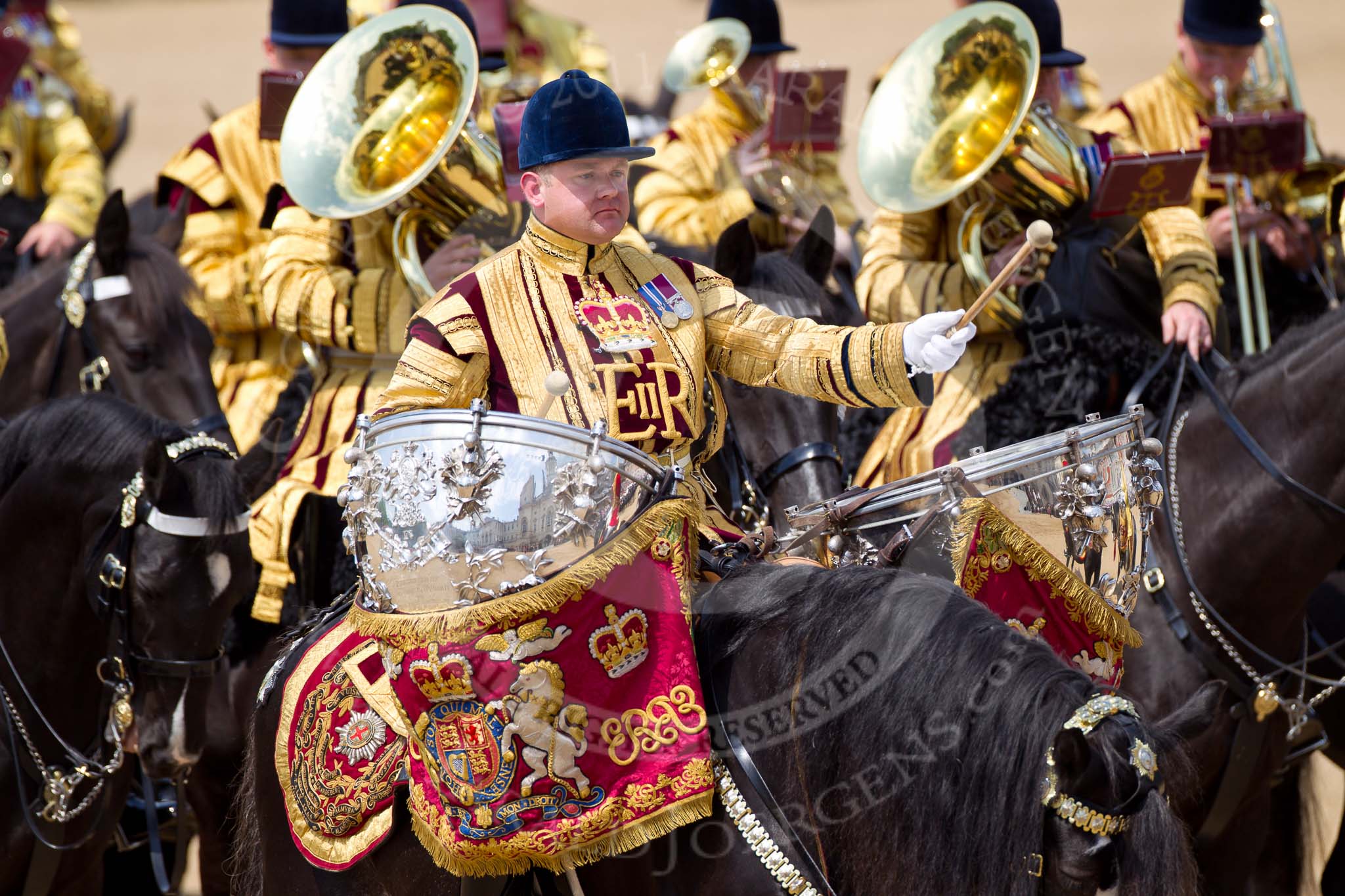 The Colonel's Review 2011: Kettle drummer of the Mounted Band of the Household Cavalry, the musicians around him playing the euphonium and the tuba..
Horse Guards Parade, Westminster,
London SW1,

United Kingdom,
on 04 June 2011 at 11:55, image #246