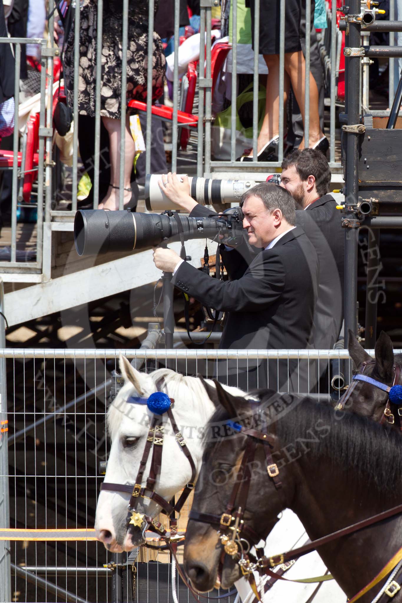 The Colonel's Review 2011: Photographers at work during the March Past, with the spectators on the grand stand behind standing as the Colour passes in front of them..
Horse Guards Parade, Westminster,
London SW1,

United Kingdom,
on 04 June 2011 at 12:08, image #295