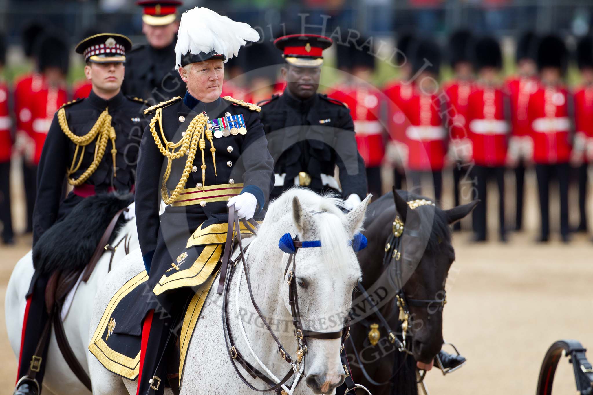 The Major General's Review 2011: The Major General that does the Major General's Review - Major General Commanding the Household Division and General Officer Commanding London District, Major General W G Cubitt, here following the carriage representing the ivory mounted phaeton that HM The Queen will be using. Behind him on the left, Captain Thomas Maitland-Mackill-Chrighton, Scots Guards, riding in place of the Duke of Kent, and Major Twumasi-Ankrah, Blues and Royals, in place of the Princess Royal..
Horse Guards Parade, Westminster,
London SW1,
Greater London,
United Kingdom,
on 28 May 2011 at 11:06, image #128