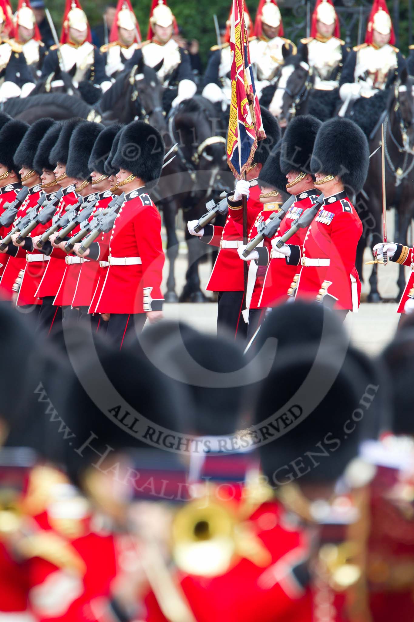 The Major General's Review 2011: The Escort to the Colour, No. 1 Guard, 1st Battalion Scots Guards, during the March Past in slow time, the Ensign, Lieutenant Tom Ogilvy, carrying the Colour. In front the Massed Bands, in the background the Household Cavalry, here the Blues and Royals..
Horse Guards Parade, Westminster,
London SW1,
Greater London,
United Kingdom,
on 28 May 2011 at 11:42, image #219