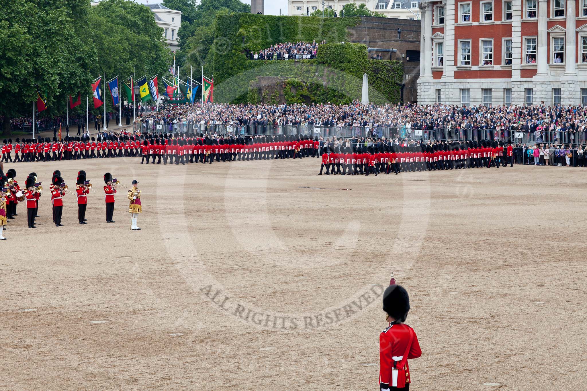 Trooping the Colour 2011: The March Past. On the left, the Massed Bands playing, marching, on the right of the photo, the guards. On Top, No. 1 Guards, the Escort to the Colour, carrying the Colour..
Horse Guards Parade, Westminster,
London SW1,
Greater London,
United Kingdom,
on 11 June 2011 at 11:41, image #260