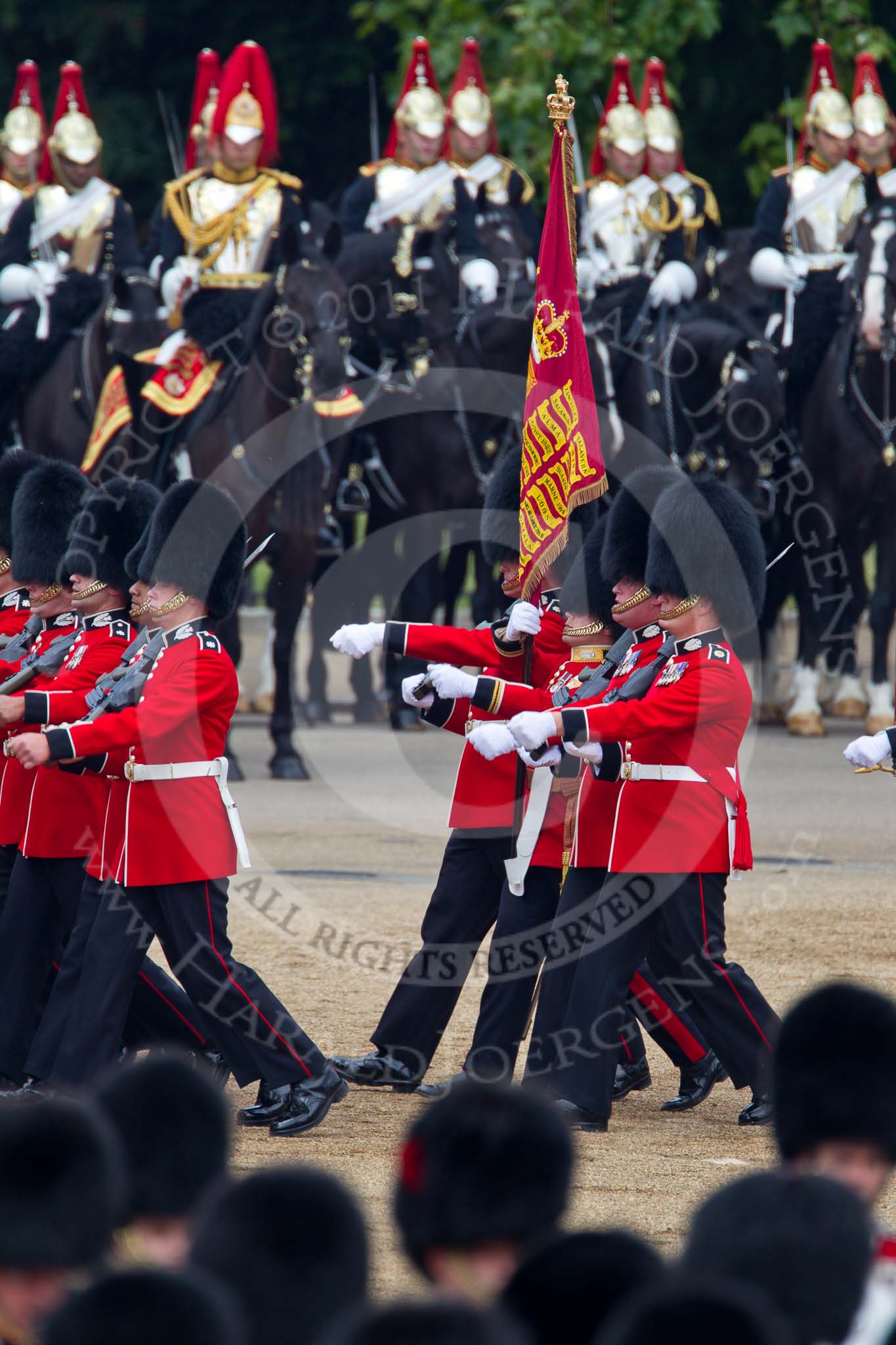 Trooping the Colour 2011: The Escort to the Colour. Carrying the flag in his white colour belt the ensign, Lieutenant Tom Ogilvy, and to his left, The Sergeant of the Ecort to the Colour, Colour Sergeant Chris Millin..
Horse Guards Parade, Westminster,
London SW1,
Greater London,
United Kingdom,
on 11 June 2011 at 11:43, image #268