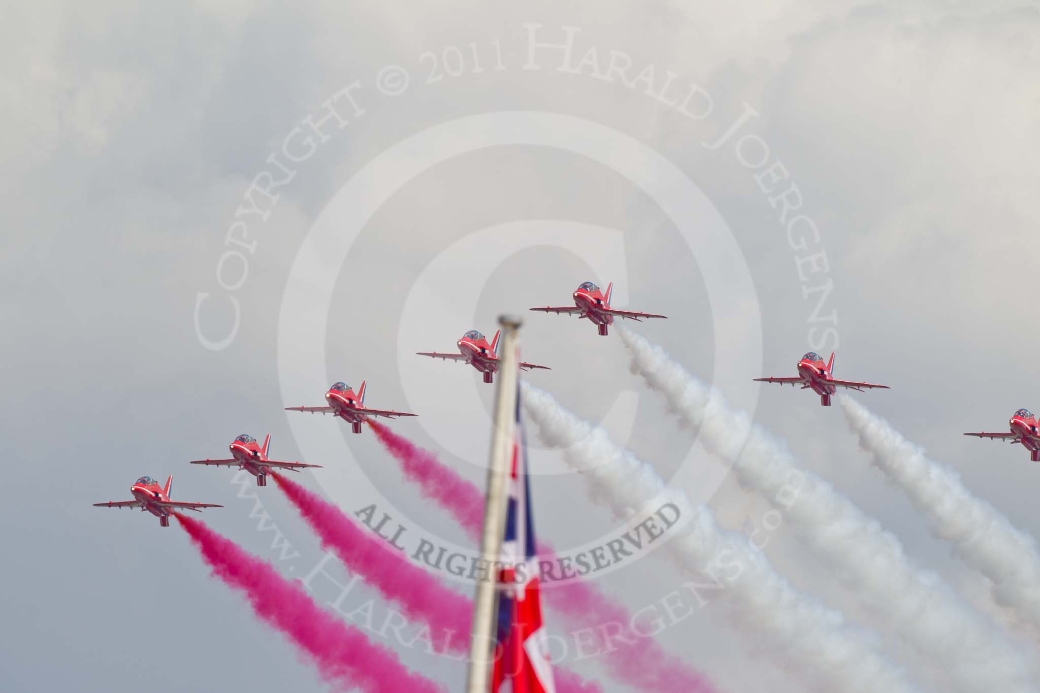 Trooping the Colour 2011: The Red Arrows, displaying red, white, and blue smoke from their Hawk aircraft, during the fly-past over Buckingham Palace..
Horse Guards Parade, Westminster,
London SW1,
Greater London,
United Kingdom,
on 11 June 2011 at 13:03, image #447