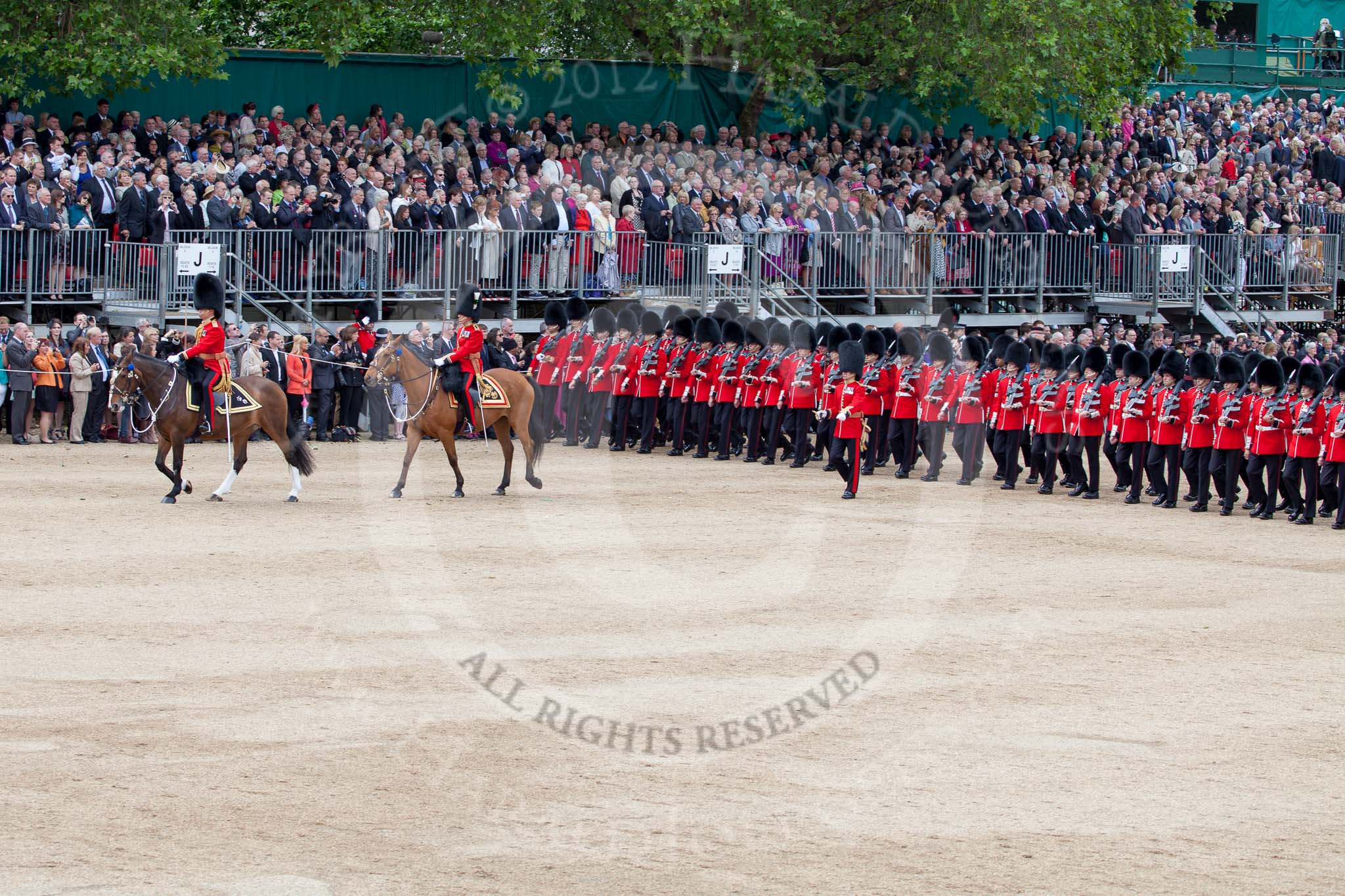 Trooping the Colour 2012: The March Past: No. 1 Guard (Escort to the Colour), 1st Battalion Coldstream Guards, marching along the western side of Horse Guards Parade for the second time. Leading are the Field Officer and the Major of the Parade..
Horse Guards Parade, Westminster,
London SW1,

United Kingdom,
on 16 June 2012 at 11:44, image #474