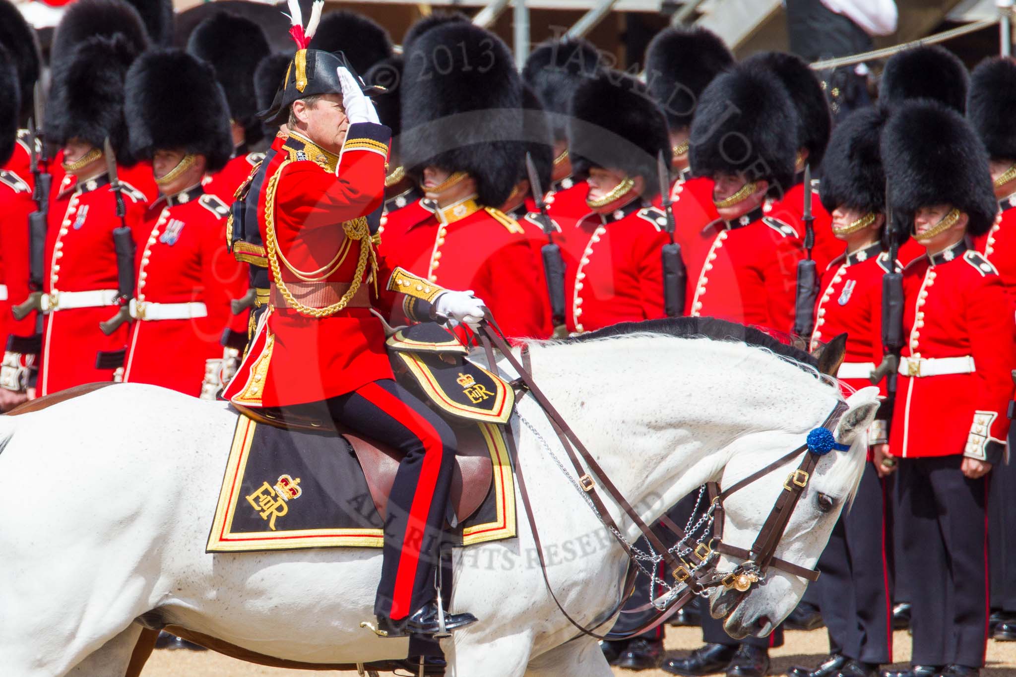 The Colonel's Review 2013: The Crown Equerry Colonel Toby Browne
Equerry in Waiting to Her Majesty, Lieutenant Colonel Alexander Matheson of Matheson, younger, saluting the Colour during the Inspection of the Line..
Horse Guards Parade, Westminster,
London SW1,

United Kingdom,
on 08 June 2013 at 11:04, image #363