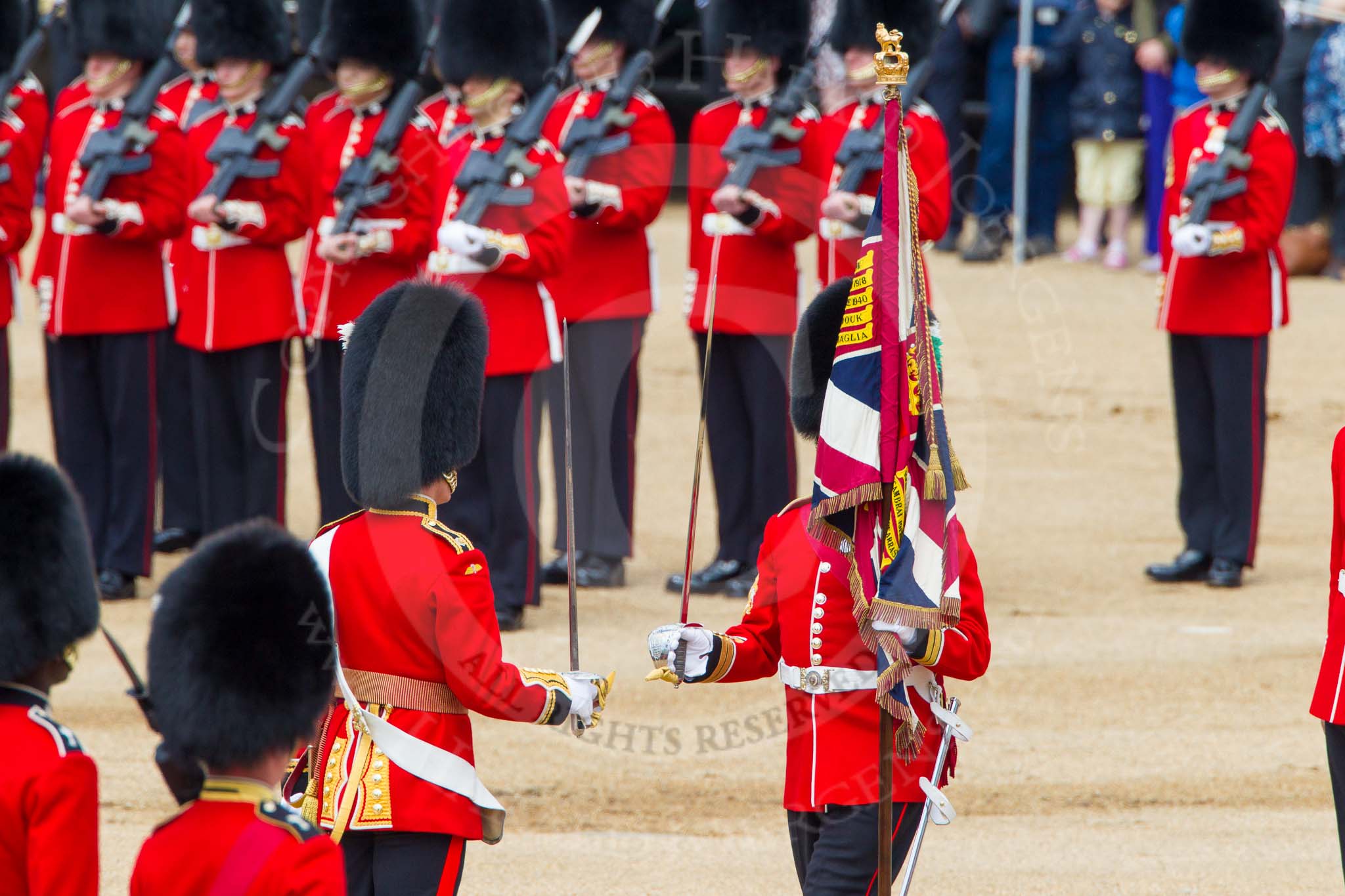 The Colonel's Review 2013: The Colour has been handed over from Colour Sergeant R J Heath, Welsh Guard to the Regimental Sergeant Major, WO1 Martin Topps, Welsh Guards. He now presents the Colour to the Ensign, Ensign, Second Lieutenant Joel Dinwiddle..
Horse Guards Parade, Westminster,
London SW1,

United Kingdom,
on 08 June 2013 at 11:19, image #512