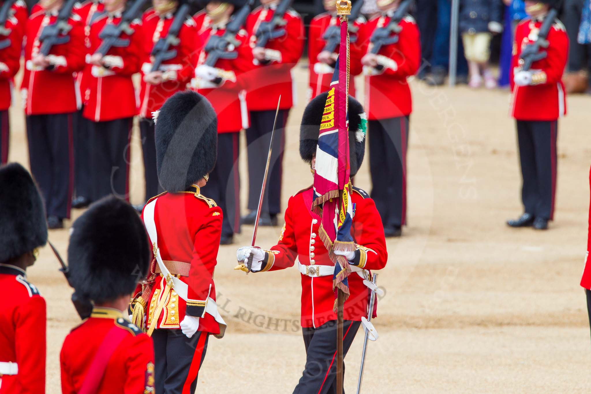 The Colonel's Review 2013: The Regimental Sergeant Major, WO1 Martin Topps, Welsh Guards  presents the Colour to the Ensign, Second Lieutenant Joel Dinwiddle, who sheathes the sword..
Horse Guards Parade, Westminster,
London SW1,

United Kingdom,
on 08 June 2013 at 11:19, image #517