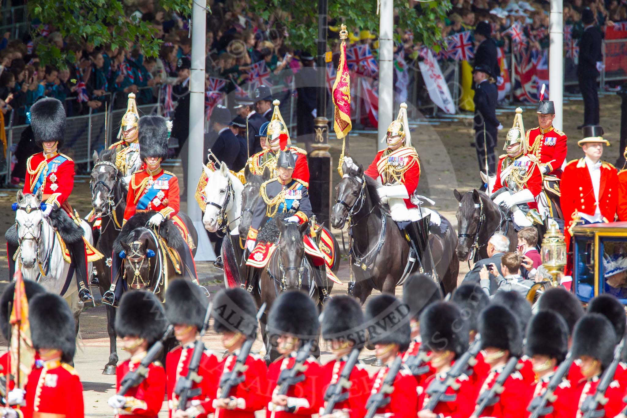 Trooping the Colour 2013: The Glass Coach carrying HM The Queen arrives at Horse Guards Parade. Behind three Royal Colonels, HRH The Duke of Cambridge, HRH The Prince of Wales, and HRH The Princess Royal. Behind them the Field Officer of the Escort, the Escort Commander, Standard Coverer, Standard Bearer, and Trumpeter. Image #255, 15 June 2013 10:58 Horse Guards Parade, London, UK