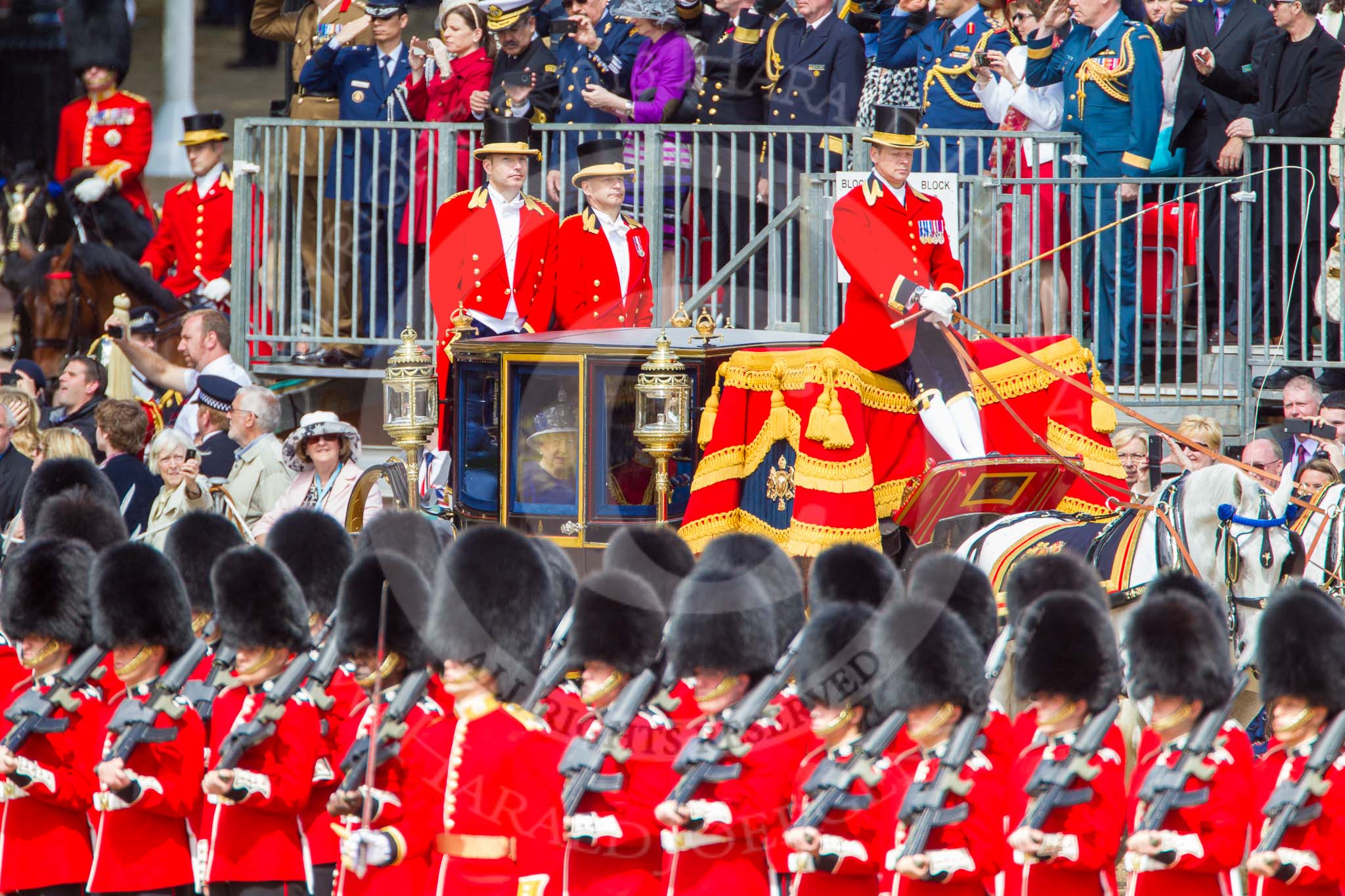 Trooping the Colour 2013: The Glass Coach carrying HM The Queen and HRH The Duke of Kent arrives as Horse Guards Parade, passing No. 6 Guard, No. 7 Company Coldstream Guards. Image #256, 15 June 2013 10:58 Horse Guards Parade, London, UK