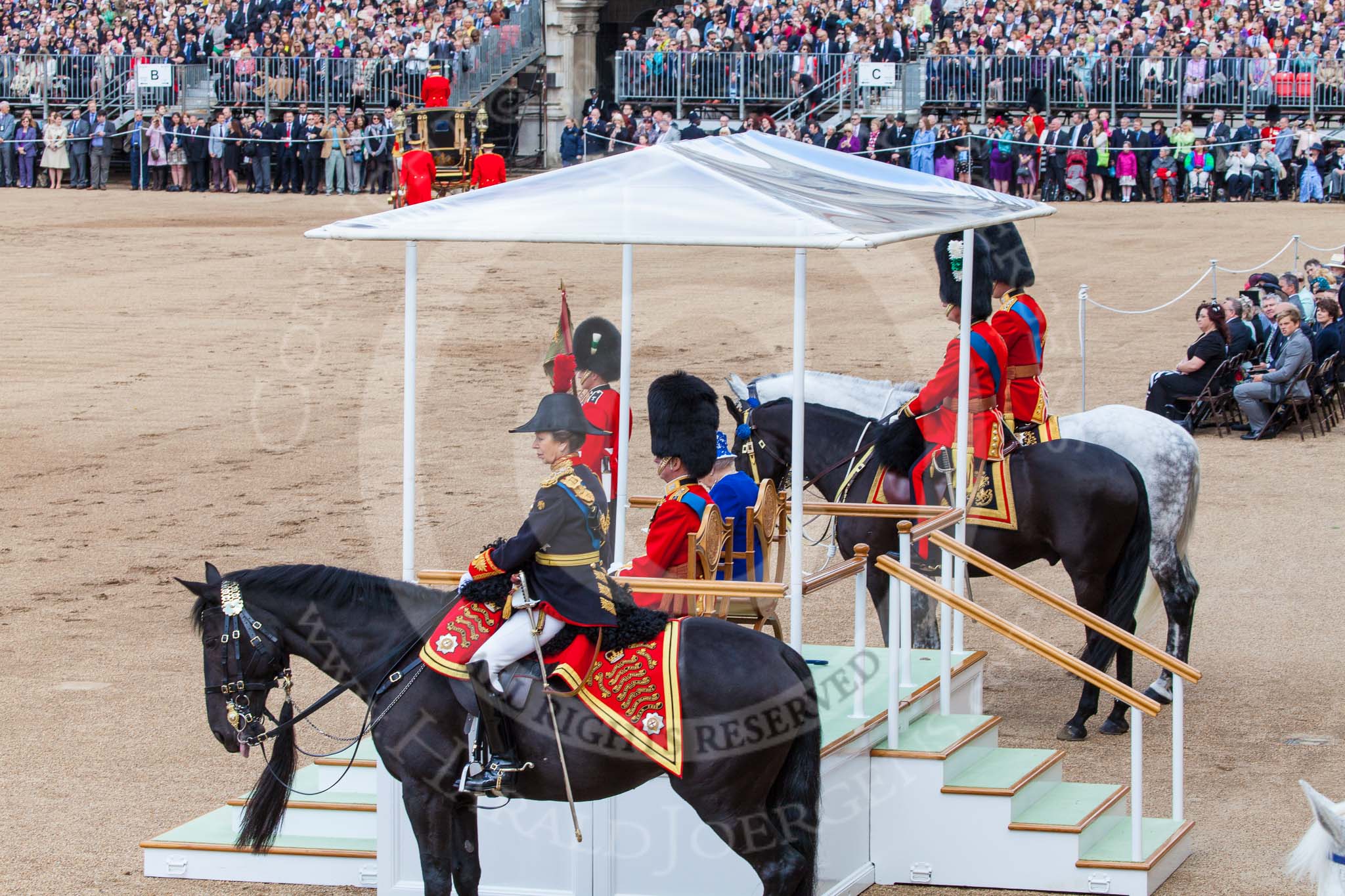 Trooping the Colour 2013: The scene after the Inspection of the Line: On the left, HRH The Proncess Royal, then the dais with HRH The Duke of Kent and HM The Queen,  next to them, on horseback, HRH The Prince of Wales and HRH The Duke of Cambridge. Image #390, 15 June 2013 11:09 Horse Guards Parade, London, UK