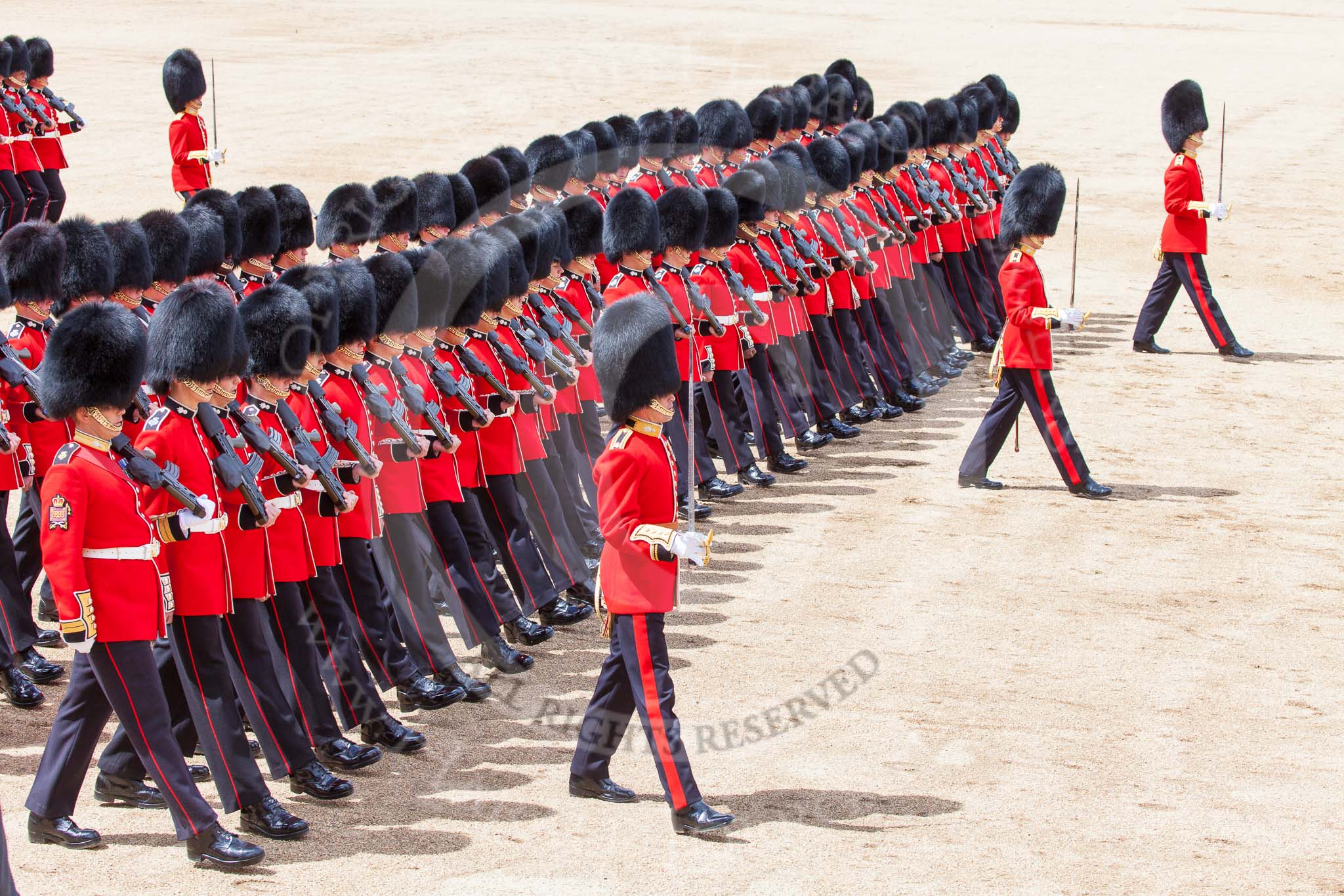 Trooping the Colour 2013: No. 4 Guard, Nijmegen Company Grenadier Guards, during the March Past, in front, with their sword drawn, Major J M Young, Second Lieutenant D R Wellham, and Lieutenant H C Cartwright. Image #547, 15 June 2013 11:37 Horse Guards Parade, London, UK