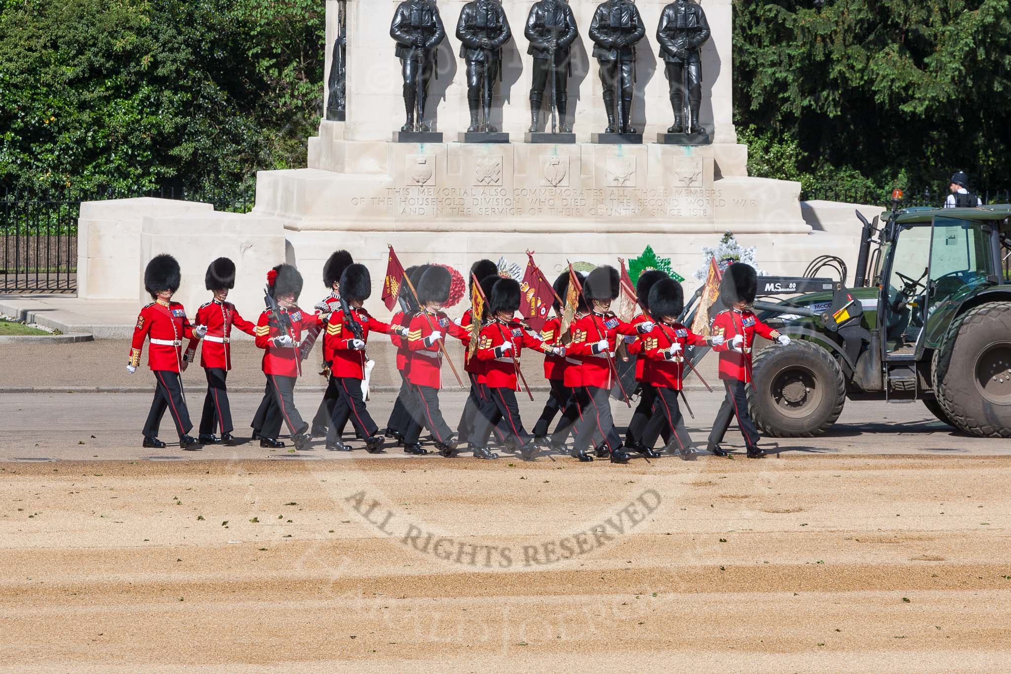 The 'Keepers of the Ground', guardsmen bearing marker flags for their respective regiments, turning towards Horse Guards Parade at the Guards Memorial