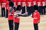 Duty Drummer  Sam Orchard uncasing the Colour held by Colour Sergeant Sam McAuley (31), with Colour Sentry Guardsman Jonathon Hughes (26) behind, during The Colonel's Review 2018 (final rehearsal for Trooping the Colour, The Queen's Birthday Parade)  at Horse Guards Parade, Westminster, London, 2 June 2018, 10:33.