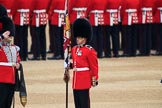 Colour Sergeant Sam McAuley (31) holding the uncased Colour, with Duty Drummer  Sam Orchard saluting, during The Colonel's Review 2018 (final rehearsal for Trooping the Colour, The Queen's Birthday Parade)  at Horse Guards Parade, Westminster, London, 2 June 2018, 10:33.