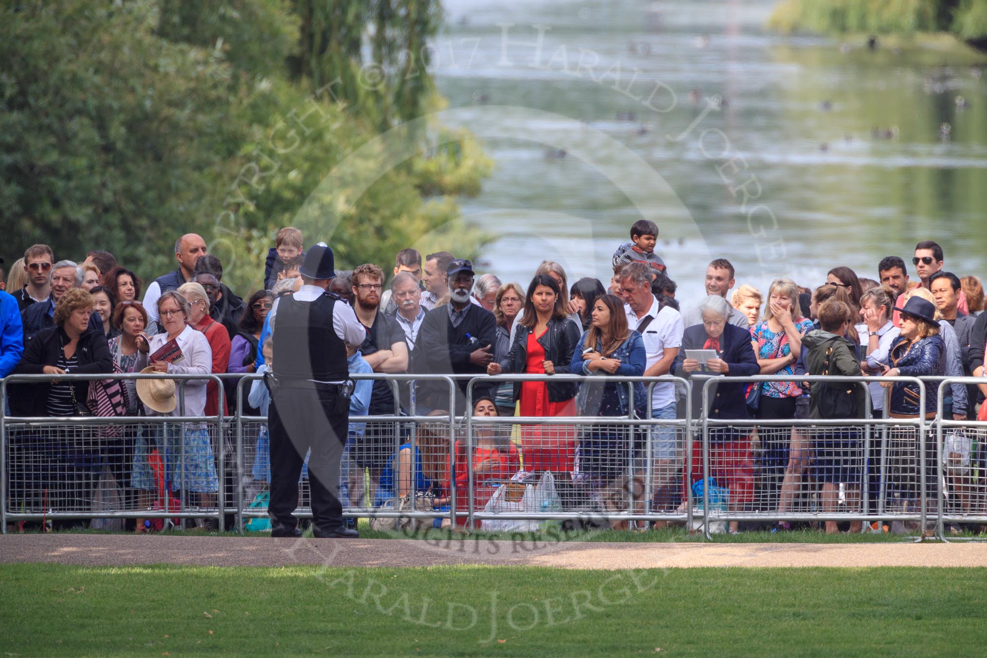 Spectators watching from St James's Park, with St James's Park Lake in the background, during Trooping the Colour 2018, The Queen's Birthday Parade at Horse Guards Parade, Westminster, London, 9 June 2018, 09:57.