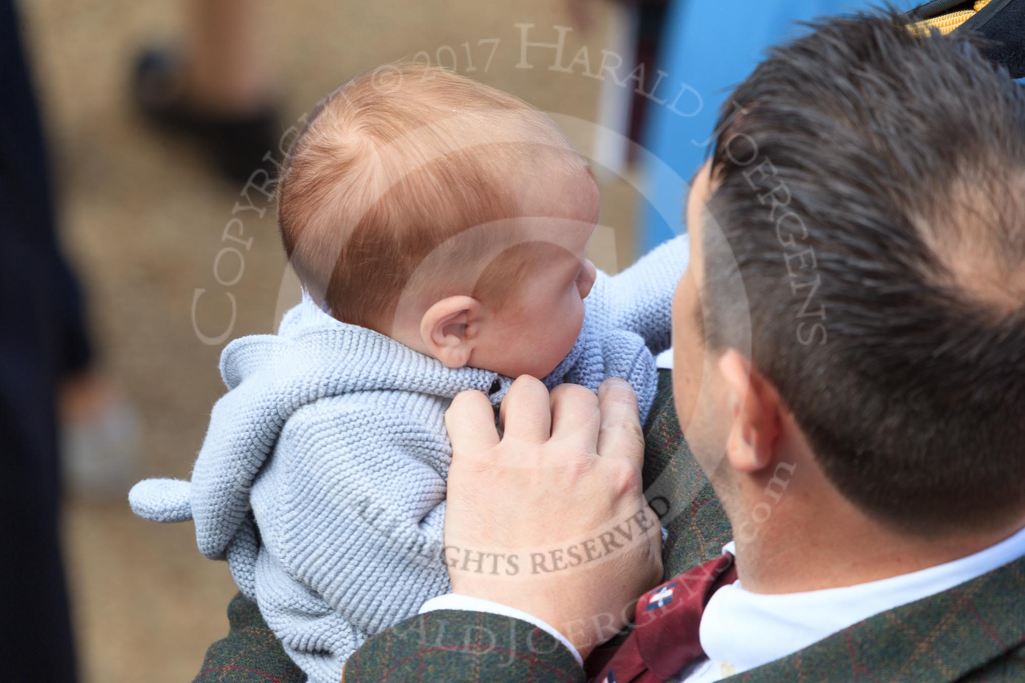 Father and baby son before Trooping the Colour 2018, The Queen's Birthday Parade at Horse Guards Parade, Westminster, London, 9 June 2018, 10:02.