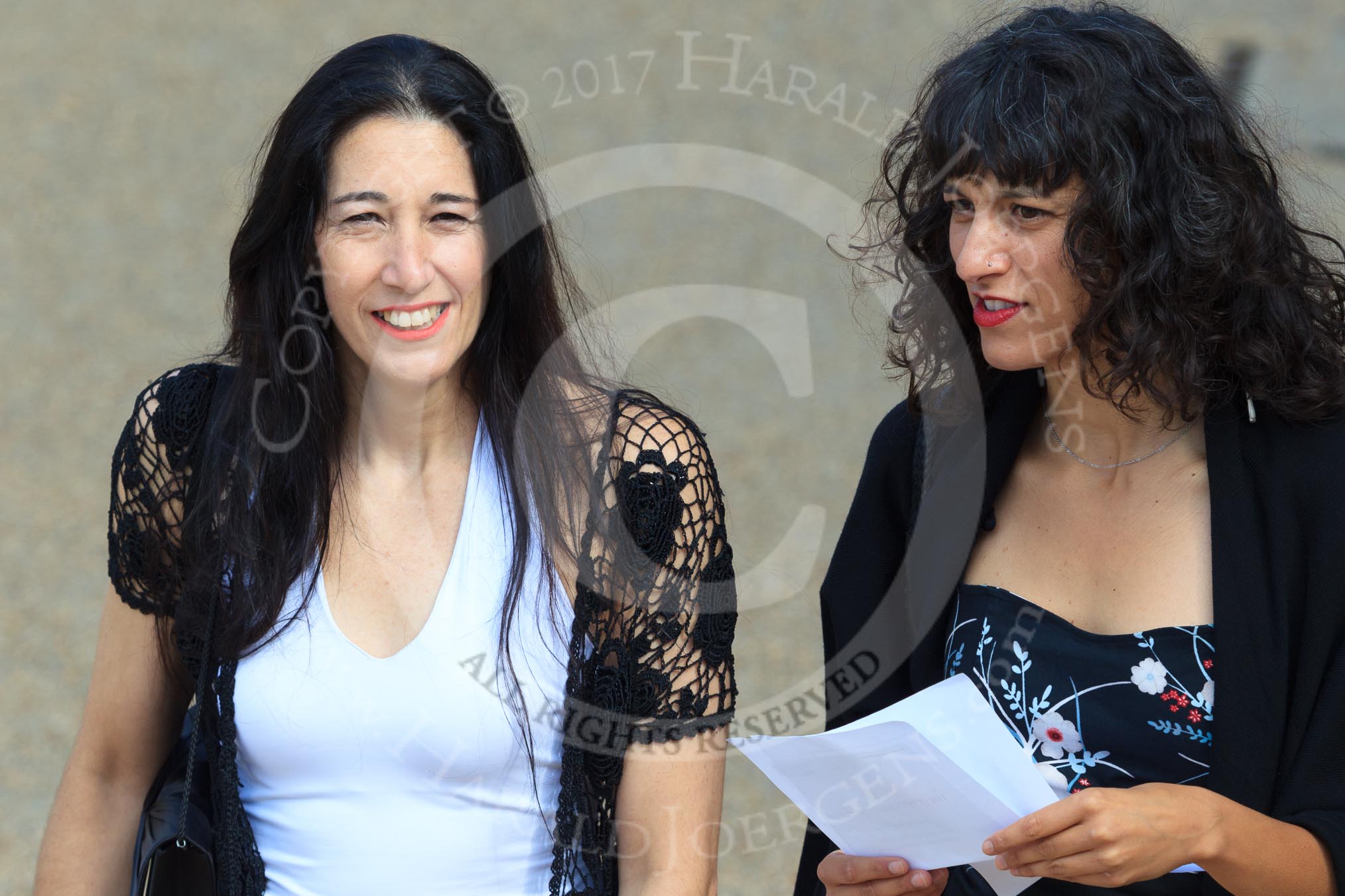 Two dark haired female spectators before Trooping the Colour 2018, The Queen's Birthday Parade at Horse Guards Parade, Westminster, London, 9 June 2018, 10:04.