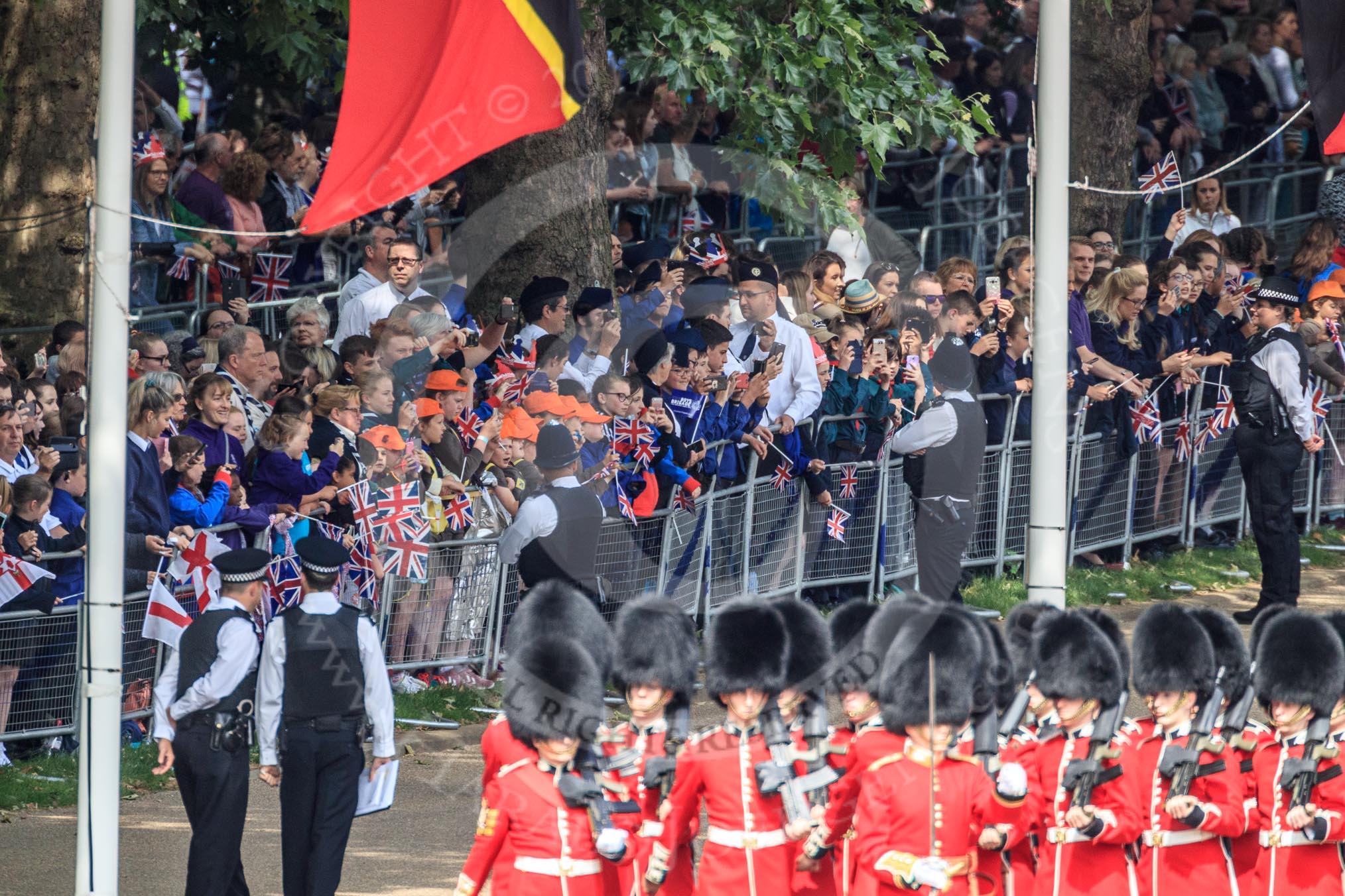 The crowded Youth Enclosure, with Number Six Guard, F Company, Scots Guards marching past, during Trooping the Colour 2018, The Queen's Birthday Parade at Horse Guards Parade, Westminster, London, 9 June 2018, 10:24.